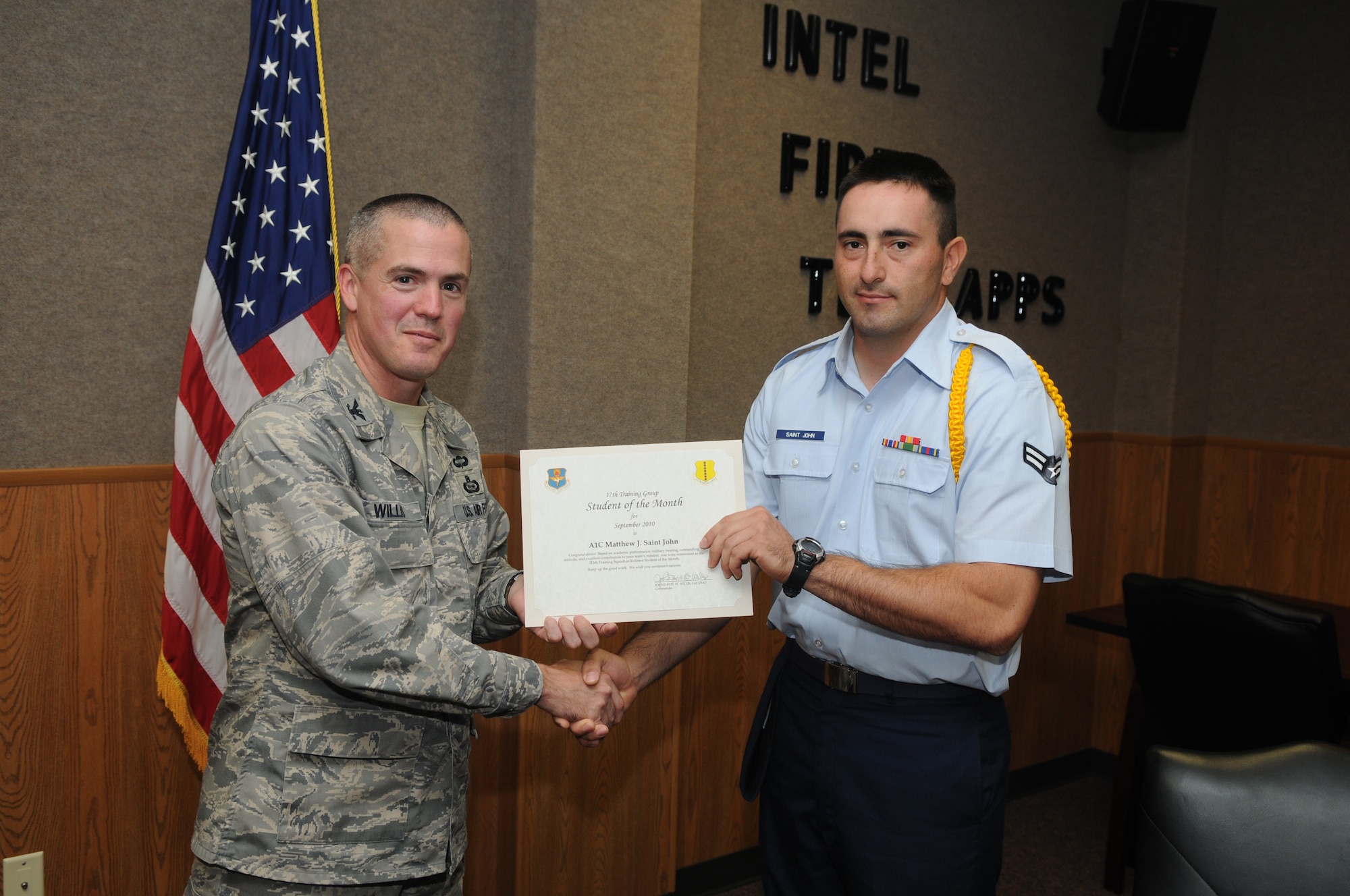 Airman 1st Class Matthew Saint John, 315th Training Squadron, accepts his September Student of the Month award from Col. J.D. Willis, 17th Training Group commander. (U.S. Air Force photo/Airman 1st Class Clayton Lenhardt)