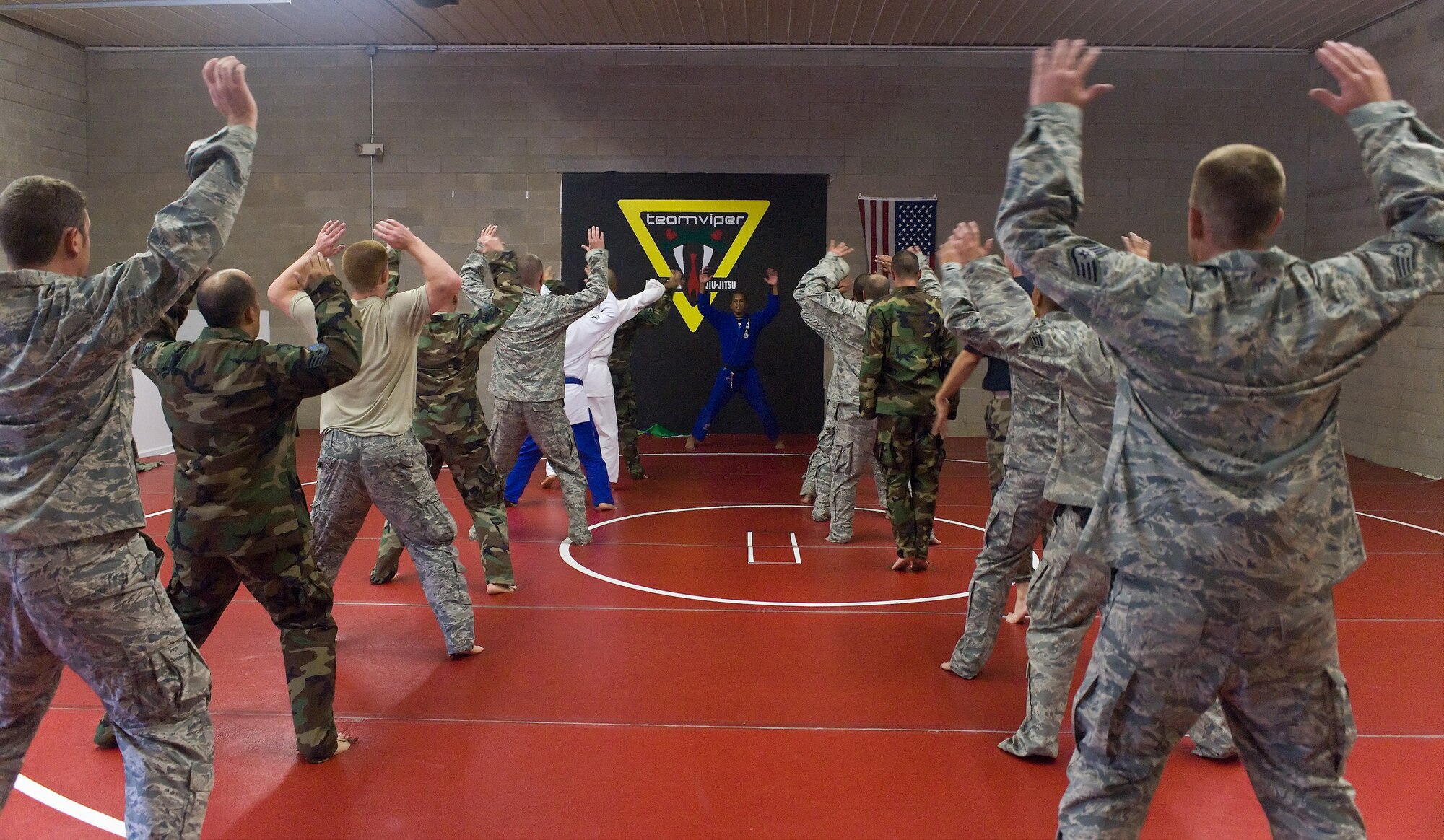 Airmen of the 436th Civil Engineer Squadron warm up prior to participating in a special martial arts seminar at Team Viper Brazilian Jiu-Jitsu in Camden, Del., Oct. 6, 2010. The seminar was taught by Vicente Junior, a third degree black belt in Brazilian Jiu-Jitsu, who taught the Airmen some basic takedowns and escapes. (U.S. Air Force photo by Roland Balik/Released)