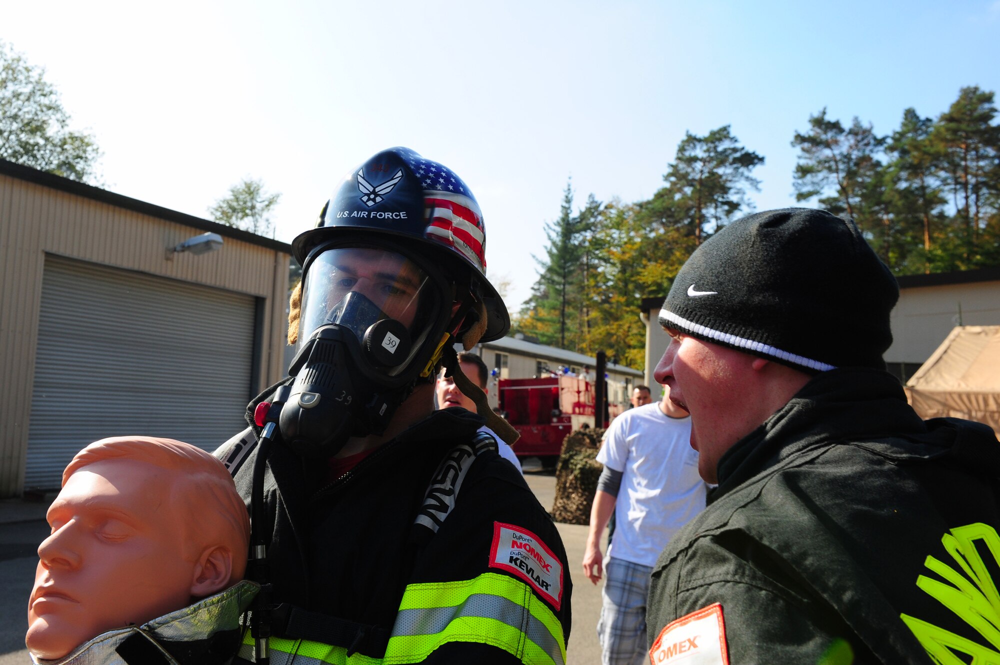 A U.S. Air Forces in Europe firefighter receives motivation from one of his teammembers during a Firefighter Combat Challenge at the 435th Construction and Training Squadron contingency training site, Ramstein Air Base, Germany, Oct. 9, 2010. The competition consisted of a timed, five part obstacle course simulating real life challenges. (U.S. Air Force photo by Airman 1st Class Brea Miller)