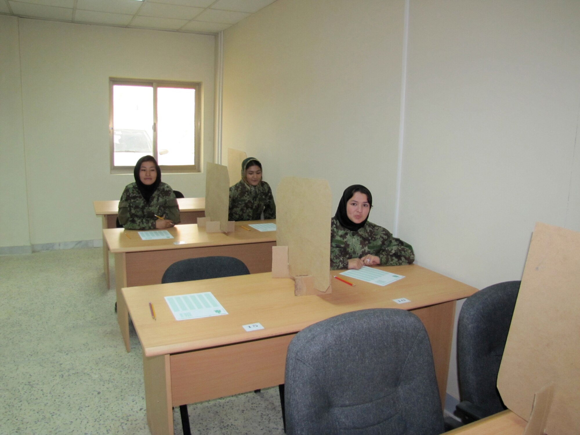 Five newly commissioned female Afghan Lieutenants take their initial English Comprehension Level assessment at the Kabul English Language Training Center at the air force base in Kabul on October 13, 2010. (Mass Communications Specialist First Class Elizabeth Burke/RELEASED).