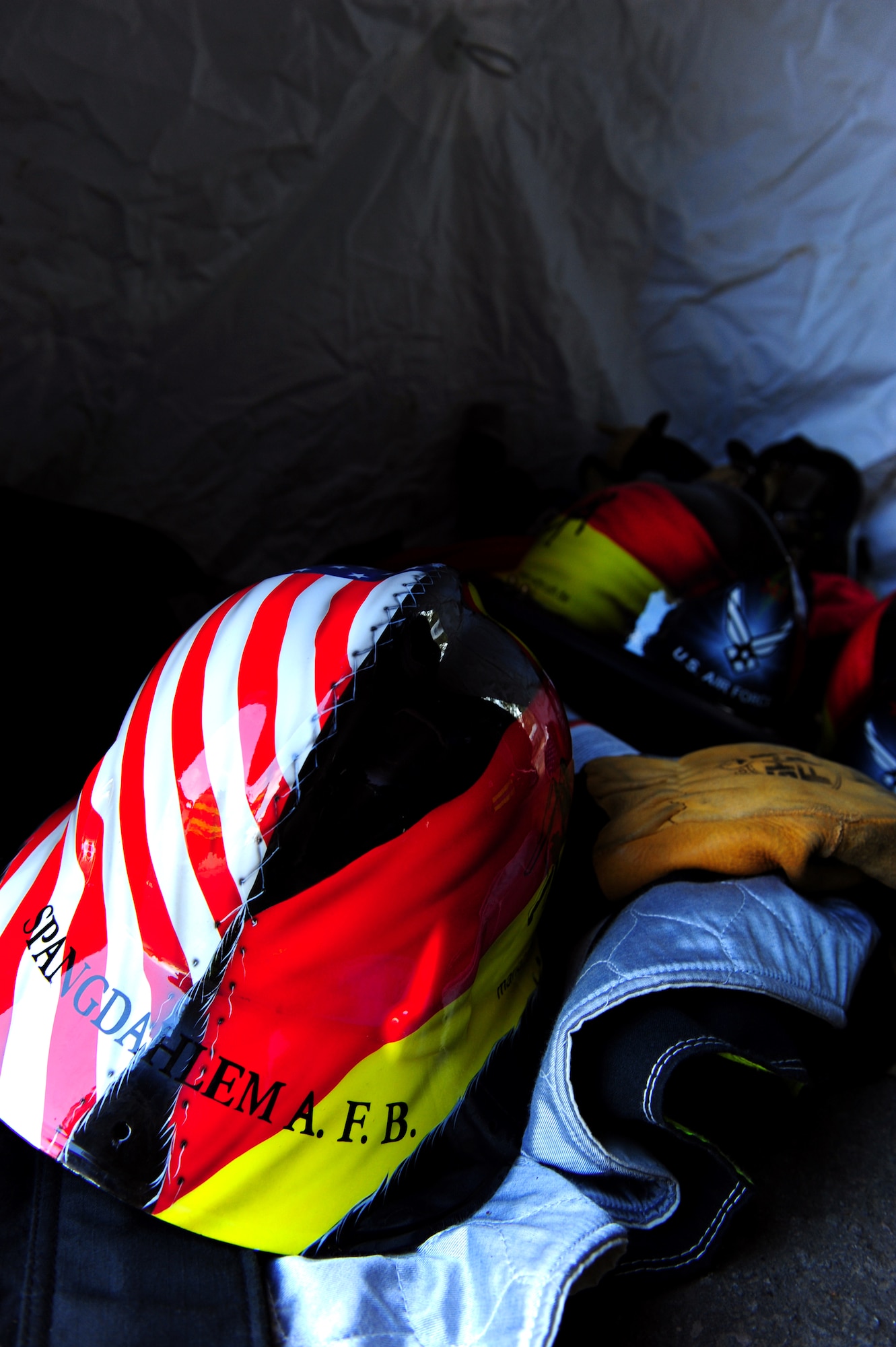 U.S. Air Forces in Europe firefighter helmets lay in a tent during a Firefighter Combat Challenge at the 435th Construction and Training Squadron contingency training site, Ramstein Air Base, Germany, Oct. 9, 2010. The competition consisted of a timed, five part obstacle course simulating real life challenges. (U.S. Air Force photo by Airman 1st Class Brea Miller)