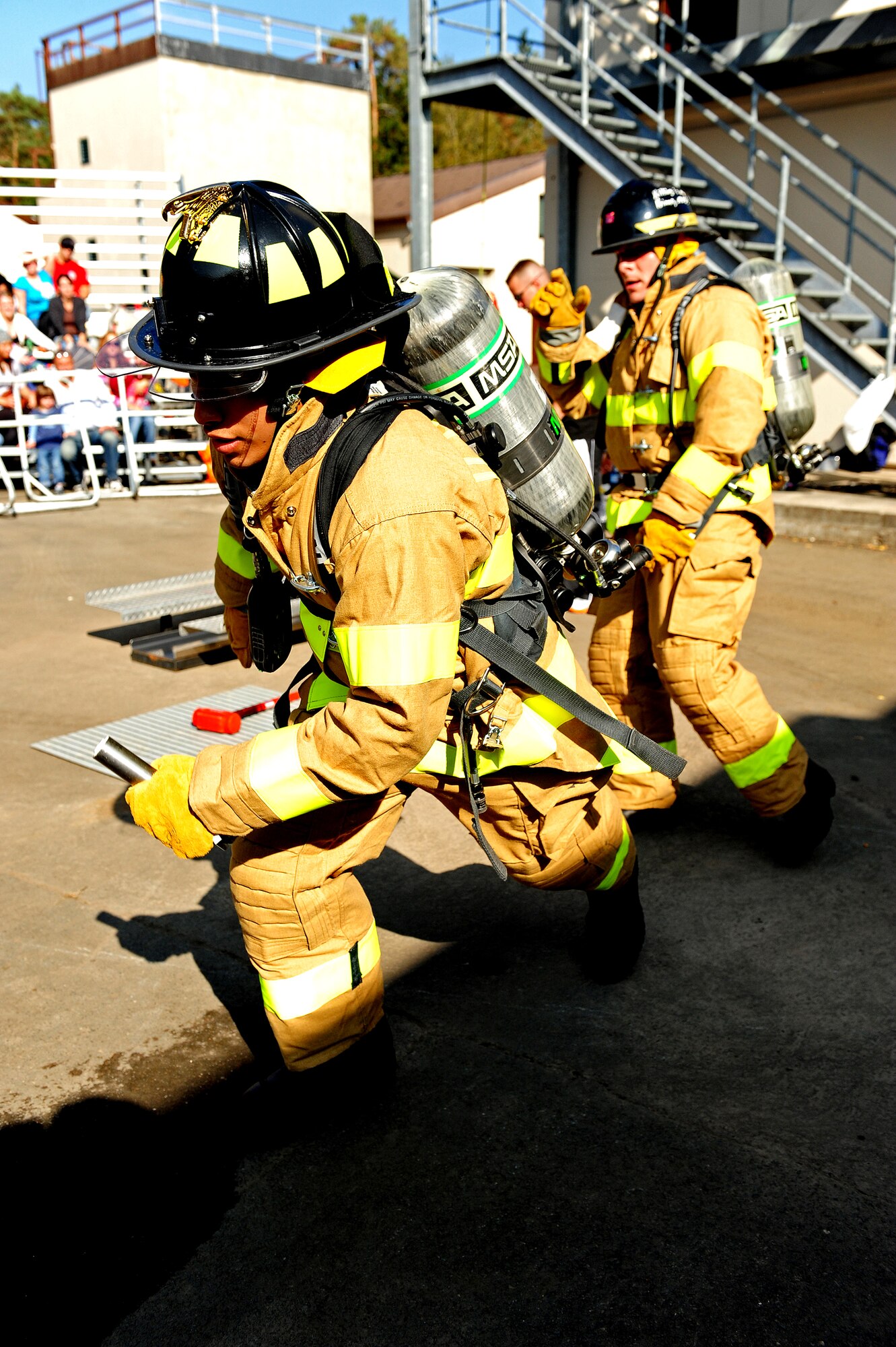 U.S. Air Forces in Europe firefighters participate in a Firefighter Combat Challenge relay race at the 435th Construction and Training Squadron contingency training site, Ramstein Air Base, Germany, Oct. 9, 2010. The competition consisted of a timed, five part obstacle course simulating real life challenges. (U.S. Air Force photo by Airman 1st Class Brea Miller)