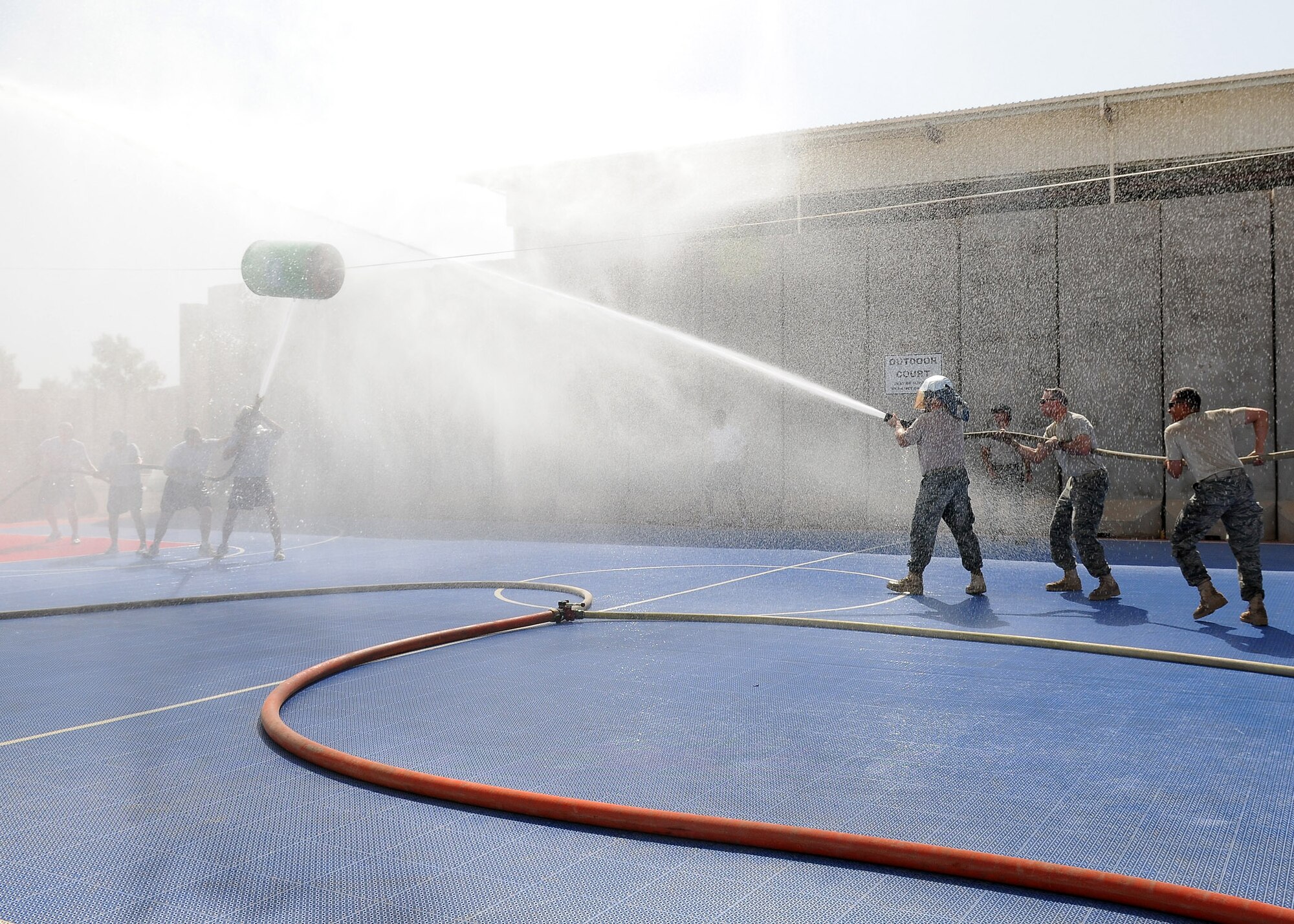“The A-Team” (left) struggles against “The Seniors” in a wet, reverse tug-of-war competition during the Fire Muster Competition Oct. 9, 2010, Joint Base Balad, Iraq.  Tug of war was one of three events in the team competition, with two out of three events won by “The Seniors.” The Fire Muster, a culmination of Fire Prevention week events from Oct. 3-10, lets non-firefighters know what it is like to be a firefighter, while at the same time promoting safety and fire prevention. (U.S. Air Force photo/Senior Airman Marianne E. Lane)