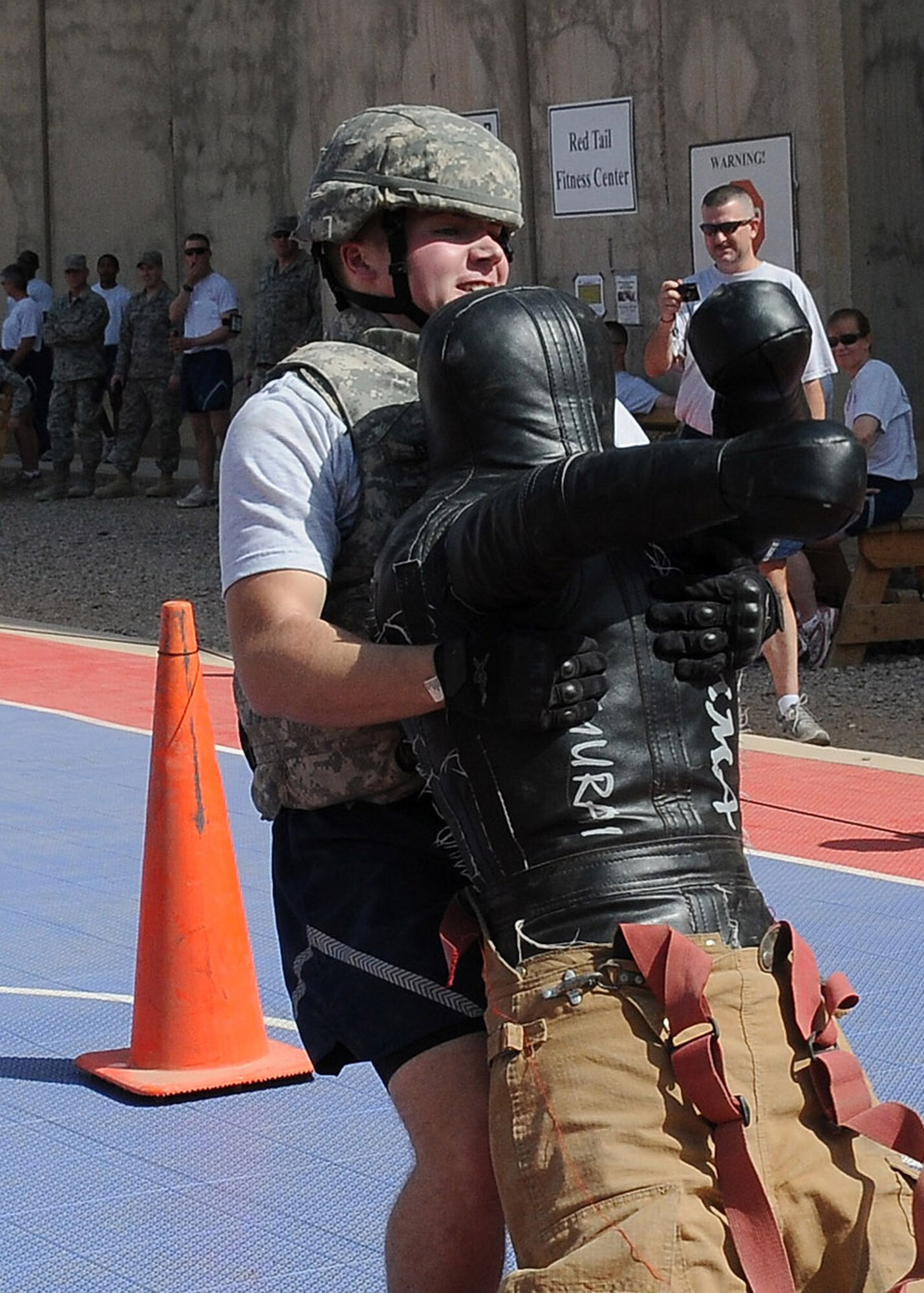 Senior Airman Nathan Krajcirik, 332nd Expeditionary Civil Engineer Squadron emergency management technician, drags a 70-pound dummy in the individual competition of the Fire Muster Competition Oct. 9, 2010, Joint Base Balad, Iraq. The Fire Muster, a culmination of Fire Prevention week events from Oct. 3-10, lets non-firefighters know what it is like to be a firefighter, while at the same time promoting safety and fire prevention. (U.S. Air Force photo/Senior Airman Marianne E. Lane)