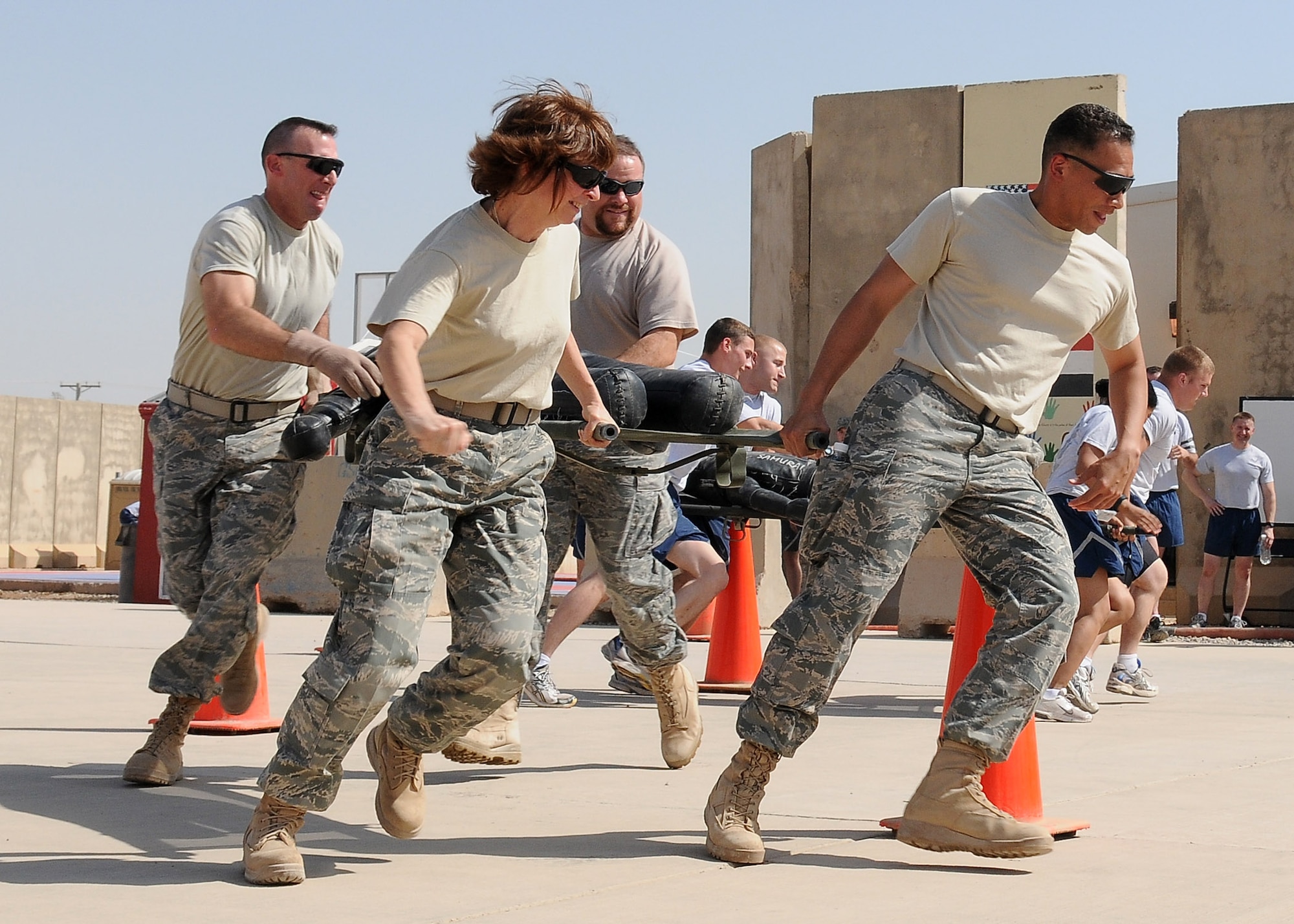 “The Seniors,” consisting of Lt. Col. Michael Vecera, Carl Voglewede, Senior Master Sgt. Deborah Hollis and Lt. Col. Arthur Primas, 332nd Air Expeditionary Wing staff carry a litter with a "patient" through a maze of cones during the Fire Muster Competition Oct. 9, 2010, Joint Base Balad, Iraq. The litter carry was one of three team events for the Fire Muster, a culmination of Fire Prevention Week events from Oct. 3-10.  “The Seniors” won this team event. (U.S. Air Force photo/Senior Airman Marianne E. Lane)
