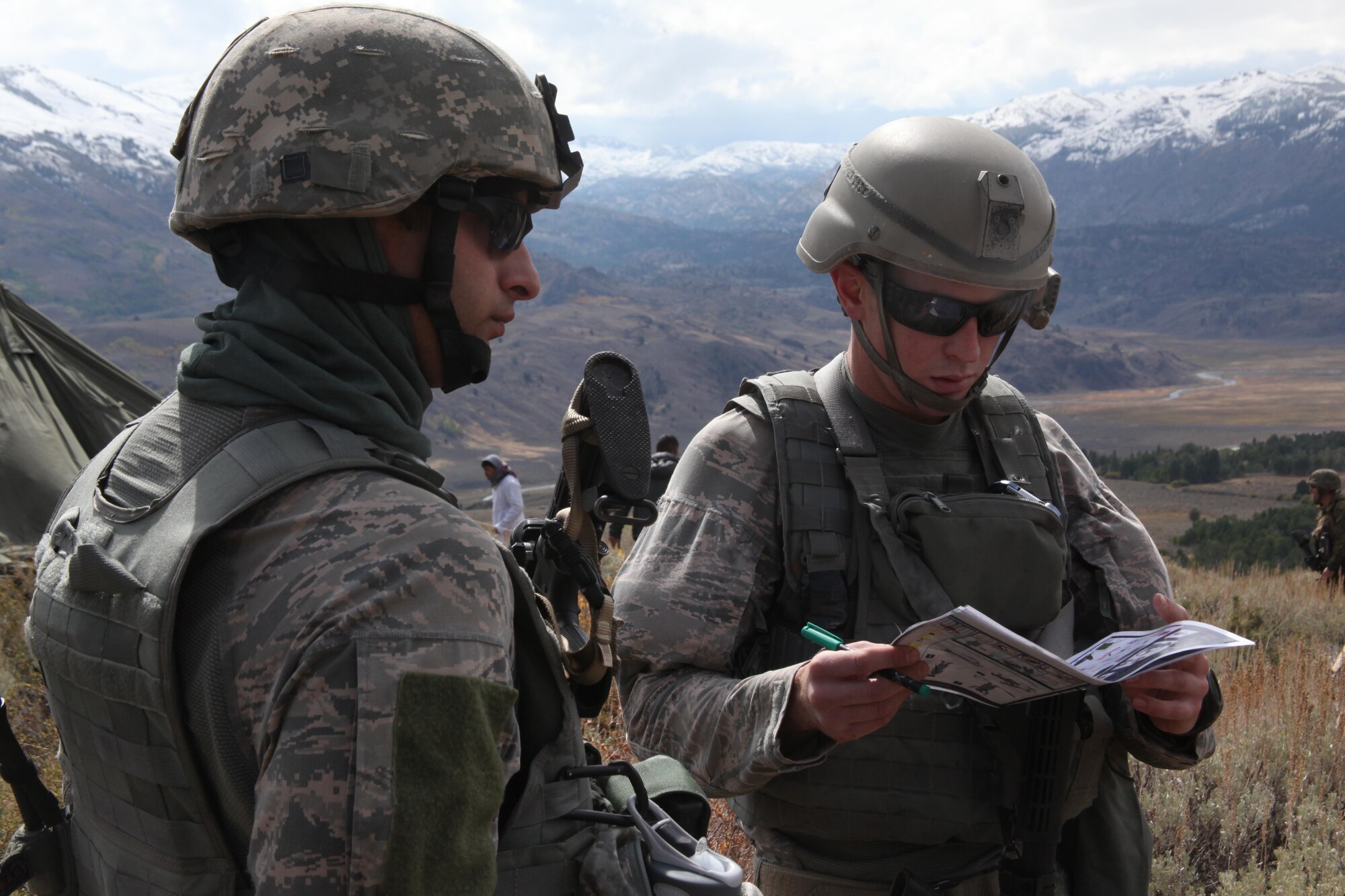 Air Force Staff Sgt. Robert Laney [left], an explosive ordnance disposal craftsman with the Air Force’s 9th EOD, and Air Force Tech Sgt. Christian McKay, an explosive ordnance disposal craftsman with 48th EOD, prepare to talk to role players posing as Afghan elders during a Cordon and Search exercise Oct. 6, 2010, at the Mountain Warfare Training Center in Bridgeport, Calif. (U.S. Marine Corps photo/Cpl. Andrew S. Avitt)