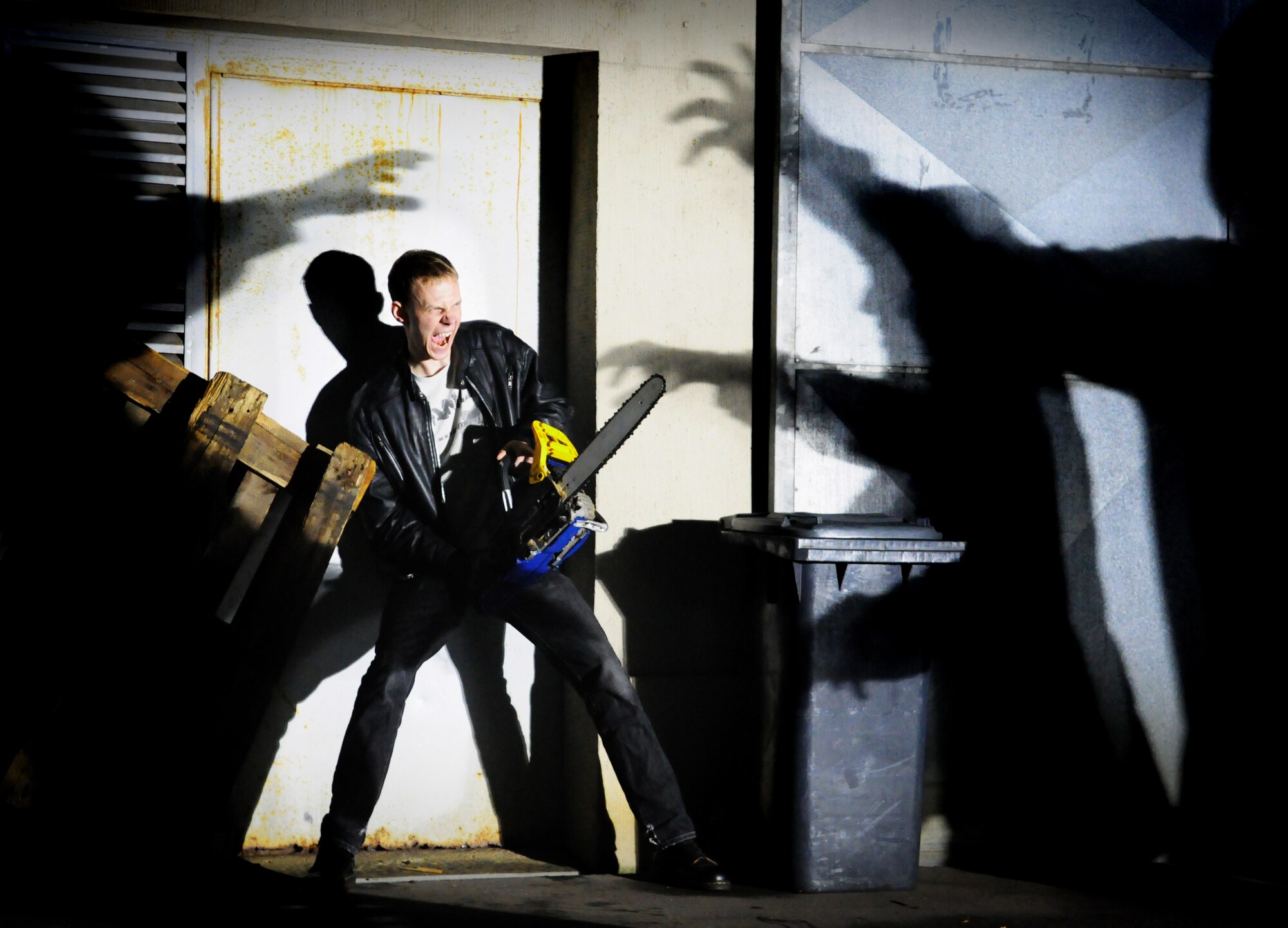 SPANGDAHLEM AIR BASE, Germany – Staff Sgt. Logan Tuttle prepares to fend off zombies using a chainsaw somewhere in the Spangdahlem area on an October night. Similar occurrences were reported in the area and local residents are advised to report all suspicious activity to emergency services. (U.S. Air Force photo/Staff Sgt. Benjamin Wilson)