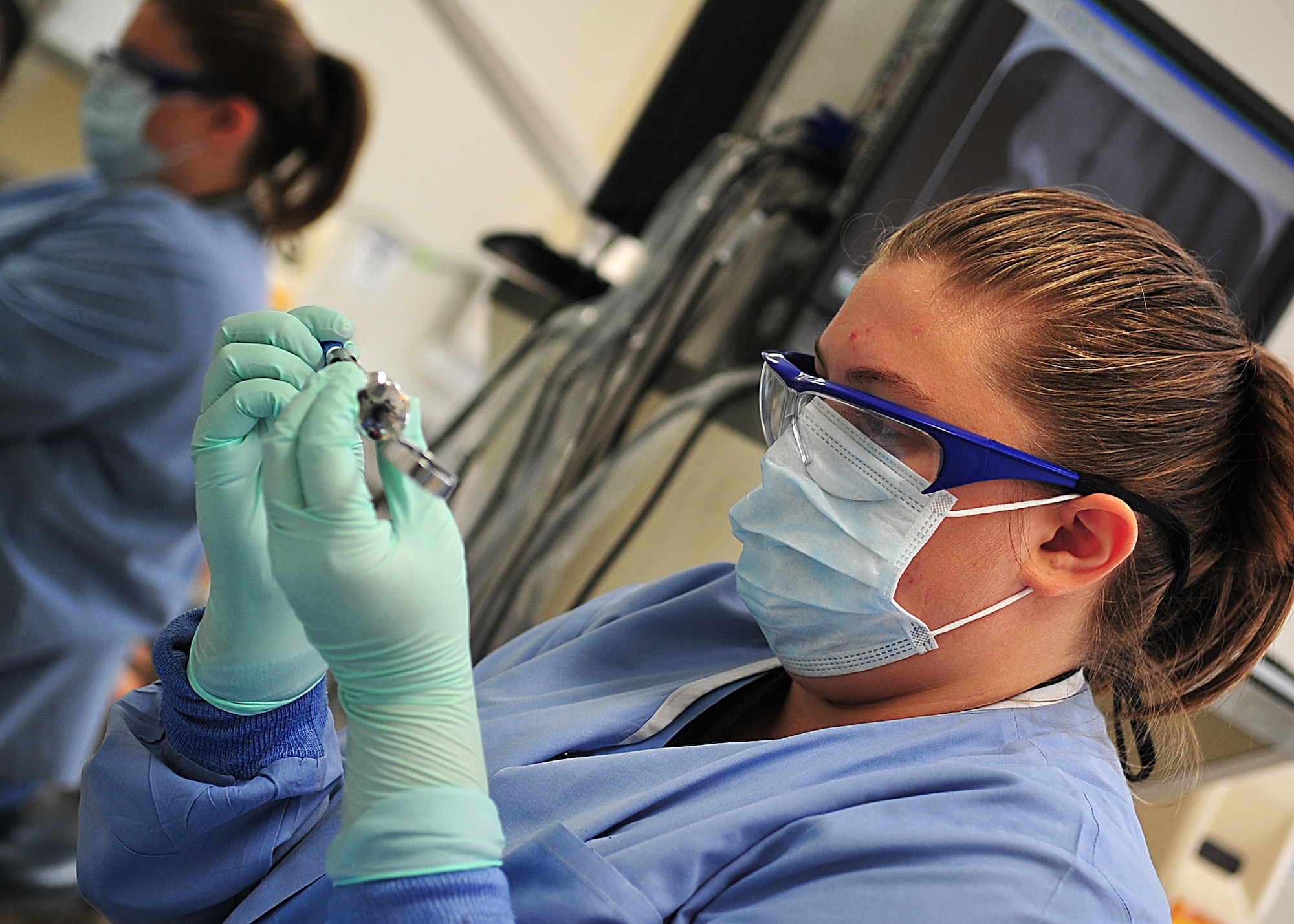 Jennifer Bissen, a student in the Red Cross Dental Assistant Training program, prepares tools prior to a dental procedure at the Kadena dental clinic Oct. 13. As part of her training, Ms. Bissen assists dentists with general dentistry and dental administration. (U.S. Air Force photo/Staff Sgt. Alesia Goosic)