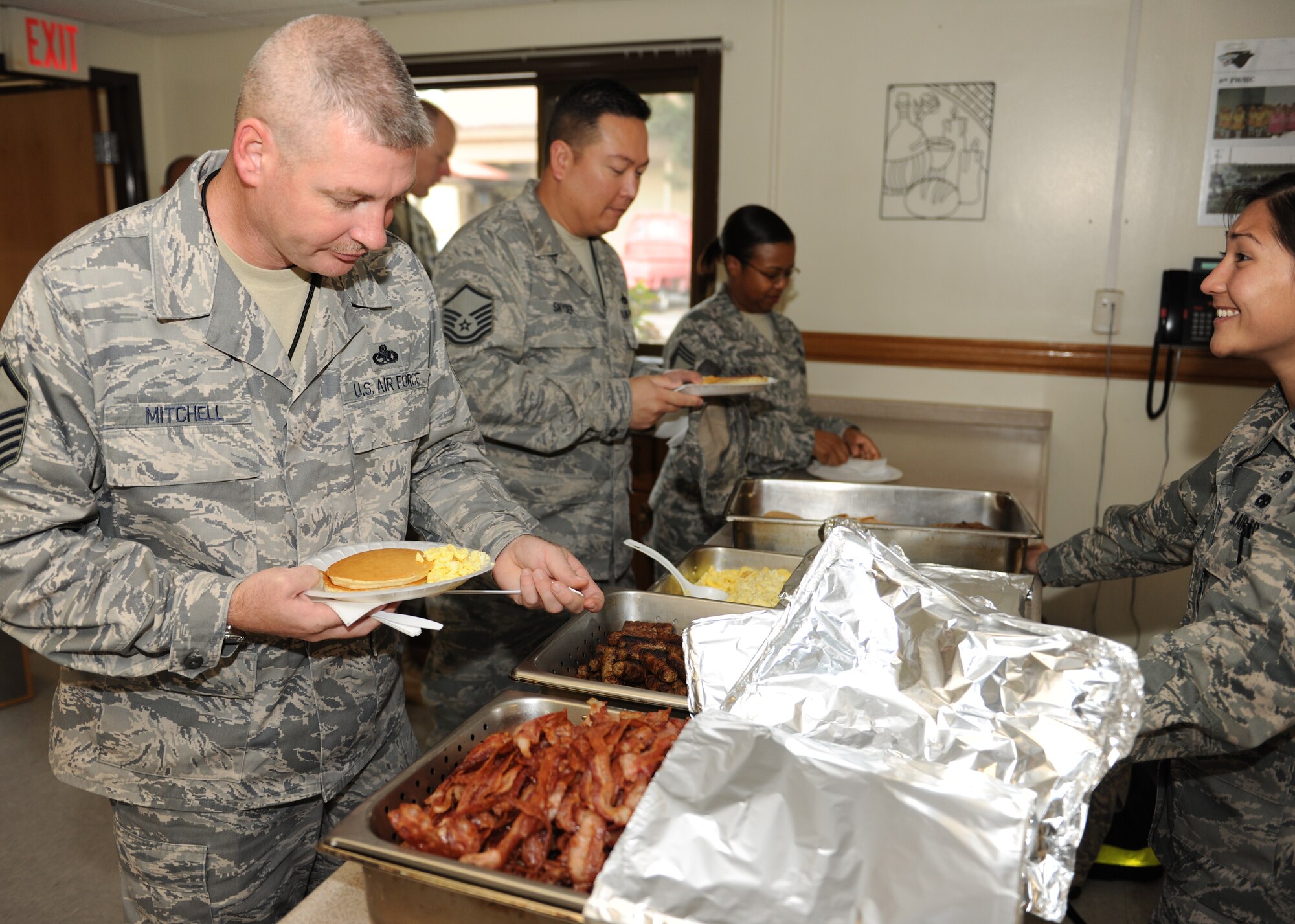 KUNSAN AIR BASE, Republic of Korea -- Airmen take complimentary breakfast served at the combined federal campaign kick-off here Oct. 13, 2010. CFC is the world’s most successful annual workplace charity campaign, with more than 300 campaigns throughout the country and internationally to help raise millions of dollars each year. (U.S. Air Force photo/Senior Airman Ciara Wymbs) 