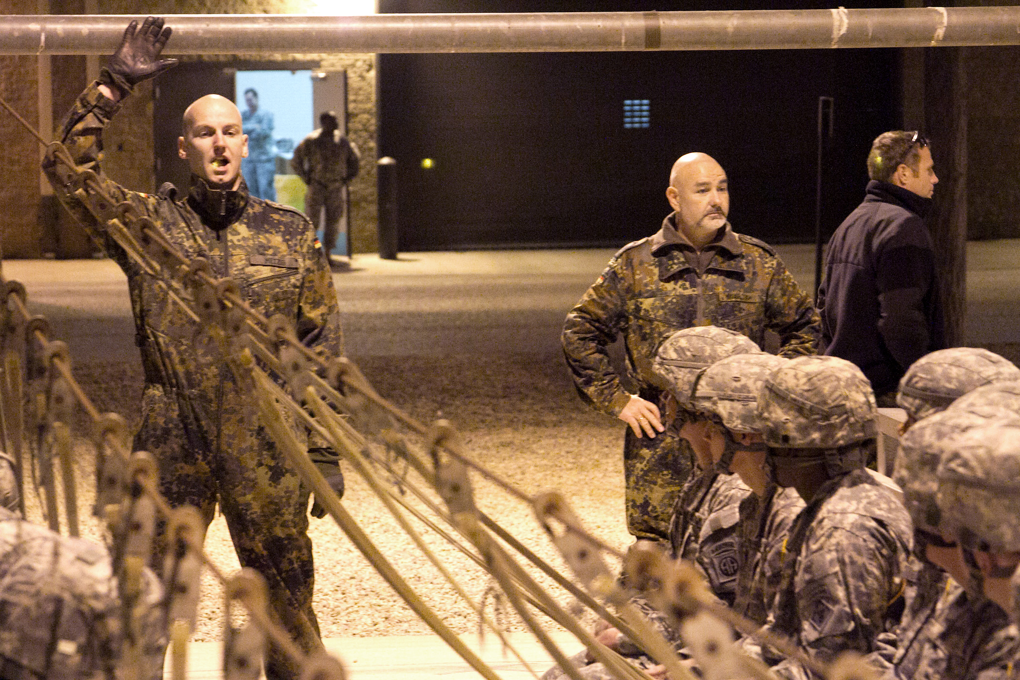 German jumpmaster Staff Sgt. Volker Metzig teaches German jump commands ...