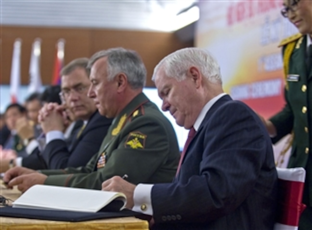 Secretary of Defense Robert M. Gates signs a Joint Declaration during a ceremony and press conference at the Association of Southeast Asian Nations Defense Ministers' Meeting Retreat at the National Convention Center in Hanoi, Vietnam, on Oct. 12, 2010.  
