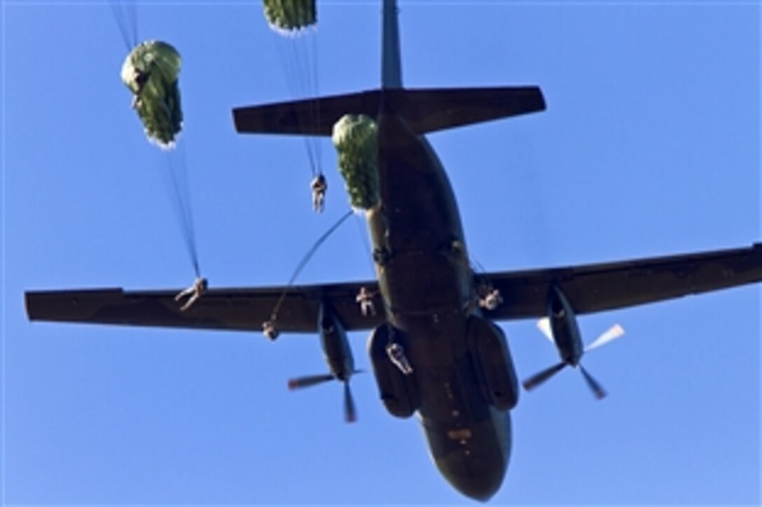 U.S. Army paratroopers exit a German C-160 aircraft over Sicily Drop Zone on Fort Bragg, N.C., Oct. 6, 2010, as part of Operation Federal Eagle during which more than 800 American paratroopers earned German jump wings. German jumpmasters aboard the aircraft supervised the jump.