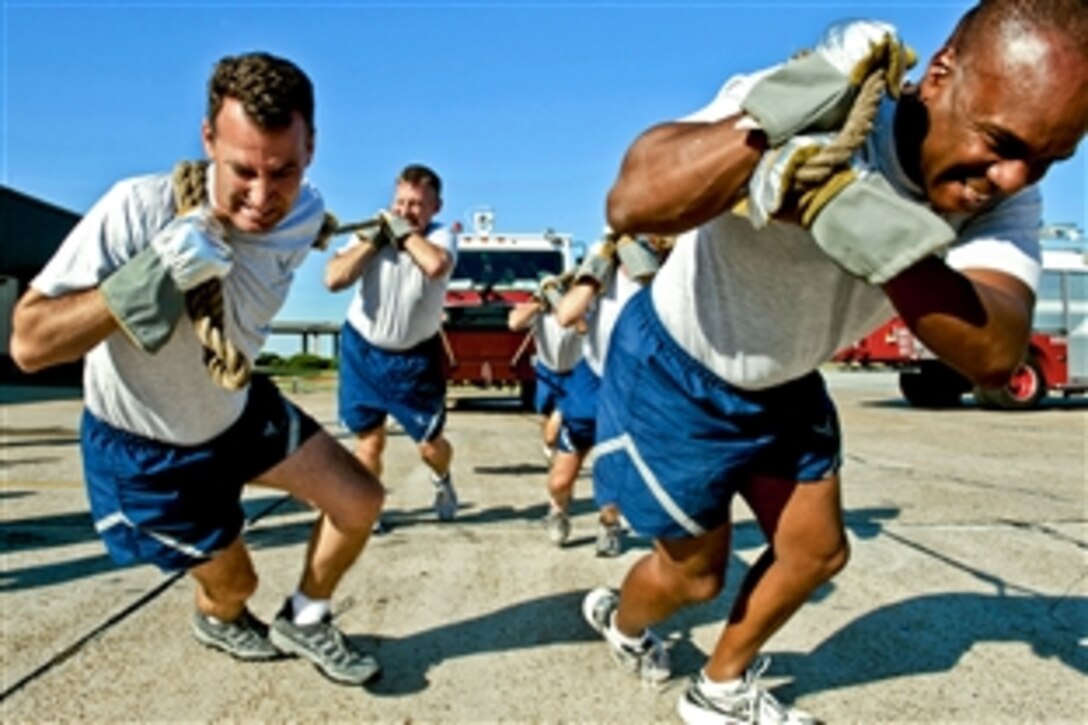U.S. Air Force Col. Chad Franks, left, and Col. Neal Robinson lead their team in a P-19 fire truck pull during Fire Prevention Week on Moody Air Force Base, Ga., Oct. 4, 2010. The team completed the pull with a time of 7:38, edging out the 23rd Logistics Readiness Squadron's fuels management flight team.