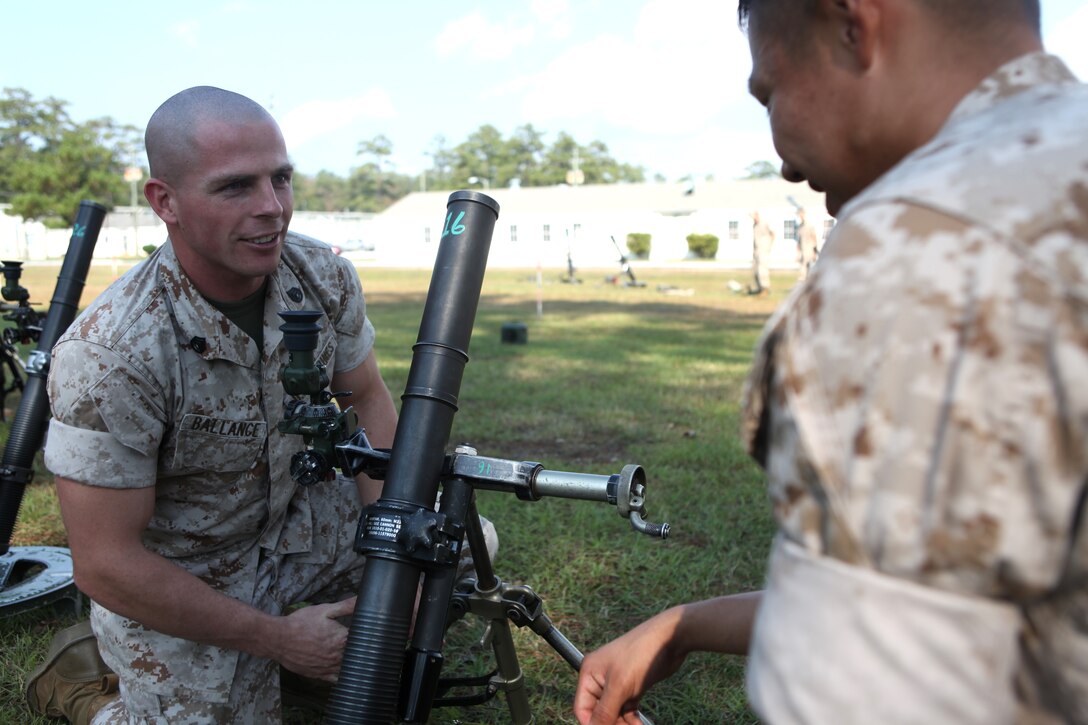 Staff Sgt. Christopher Ballance, an infantry unit leader and instructor in the Infantry Mortar Leader’s Course aboard Camp Geiger, goes over mortar gunnery techniques with a student in the IMLC, Oct. 14. Not only has Ballance done exceptionally well as an athlete outside of the Marine Corps, he has also excelled as a Marine combat instructor in his battalion.