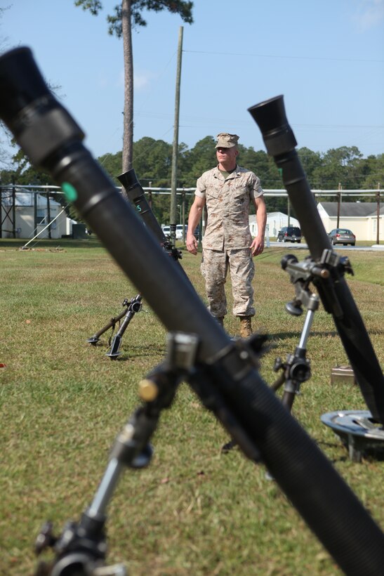 Staff Sgt. Christopher Ballance, an infantry unit leader and instructor in the Infantry Mortar Leader’s Course aboard Camp Geiger, takes a moment to pose among mortars Oct. 14. Ballance has become a model Marine in his battalion, with instructing young Marines and leading physical training, as well as outside of the Marine Corps as a world class powerlifter.