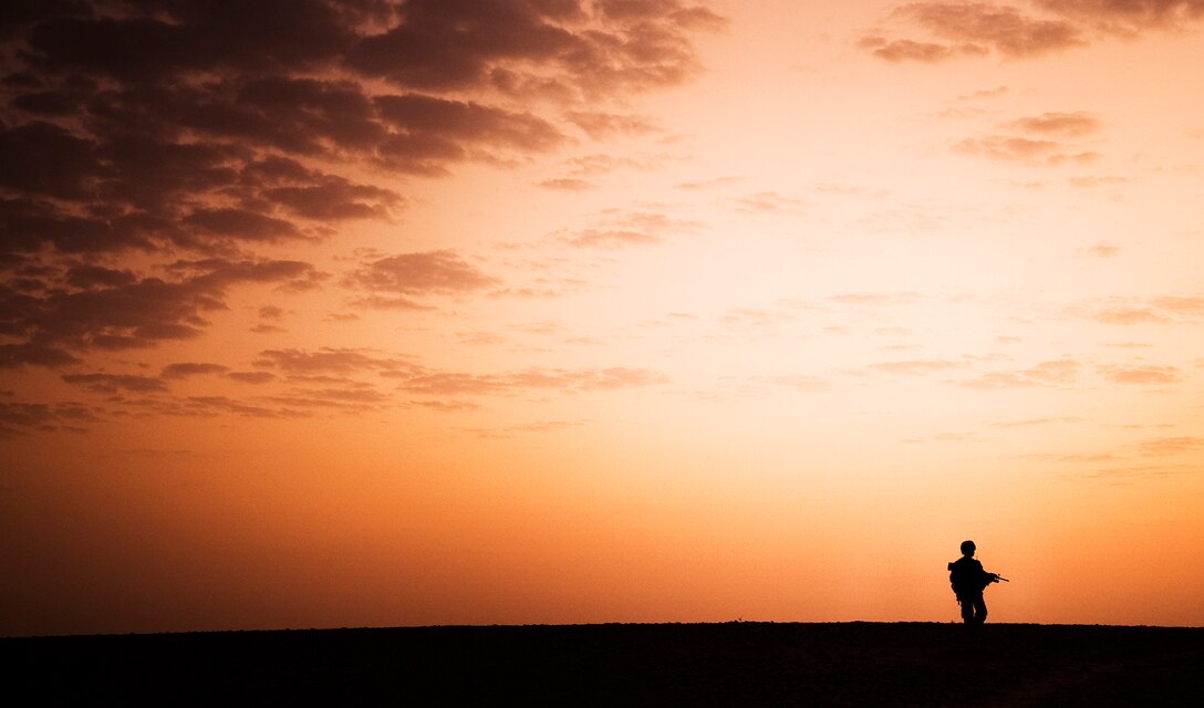 Lance Cpl. Tylon William, a team leader with India Company, 3rd Battalion, 3rd Marine Regiment, patrols through Trek Nawa, Afghanistan, just before sunrise, during Operation Black Tip, Oct. 14, 2010. Black Tip was a one-day clearing operation to disrupt enemy activity, during which the Marines, partnered with Afghan soldiers from the 1st Kandak, 1st Brigade, 215th Corps, detained four men suspected of combatant activity and removed a weapons cache from the area. William is from Compton, Calif.