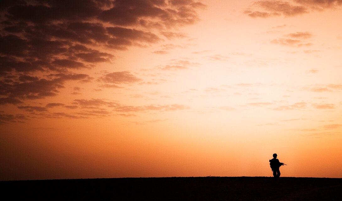 Lance Cpl. Tylon William, a team leader with India Company, 3rd Battalion, 3rd Marine Regiment, patrols through Trek Nawa, Afghanistan, just before sunrise, during Operation Black Tip, Oct. 14, 2010. Black Tip was a one-day clearing operation to disrupt enemy activity, during which the Marines, partnered with Afghan soldiers from the 1st Kandak, 1st Brigade, 215th Corps, detained four men suspected of combatant activity and removed a weapons cache from the area. William is from Compton, Calif.