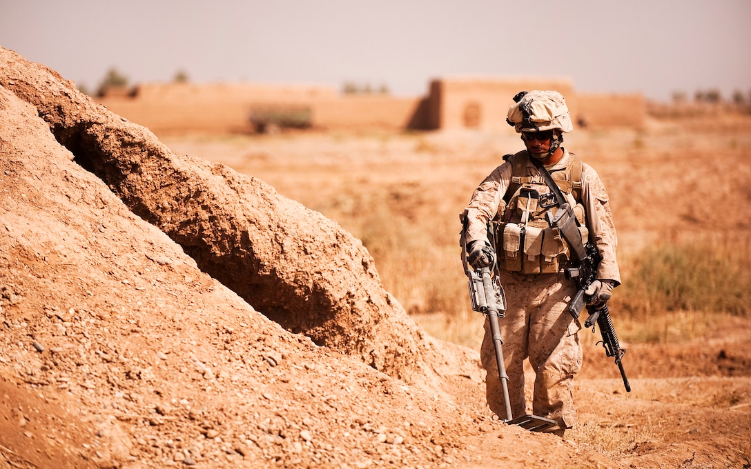 TREK NAWA, Helmand province, Islamic Republic of Afghanistan — Lance Cpl. Moises Garcia, an engineer with India Company, 3rd Battalion, 3rd Marine Regiment, sweeps for weapons caches in Trek Nawa, Afghanistan, during Operation Black Tip, Oct. 14, 2010. Black Tip was a one-day clearing operation to disrupt enemy activity, during which the Marines, partnered with Afghan soldiers from the 1st Kandak, 1st Brigade, 215th Corps, detained four men suspected of combatant activity and removed a weapons cache from the area. Garcia is from Brownsville, Texas.
