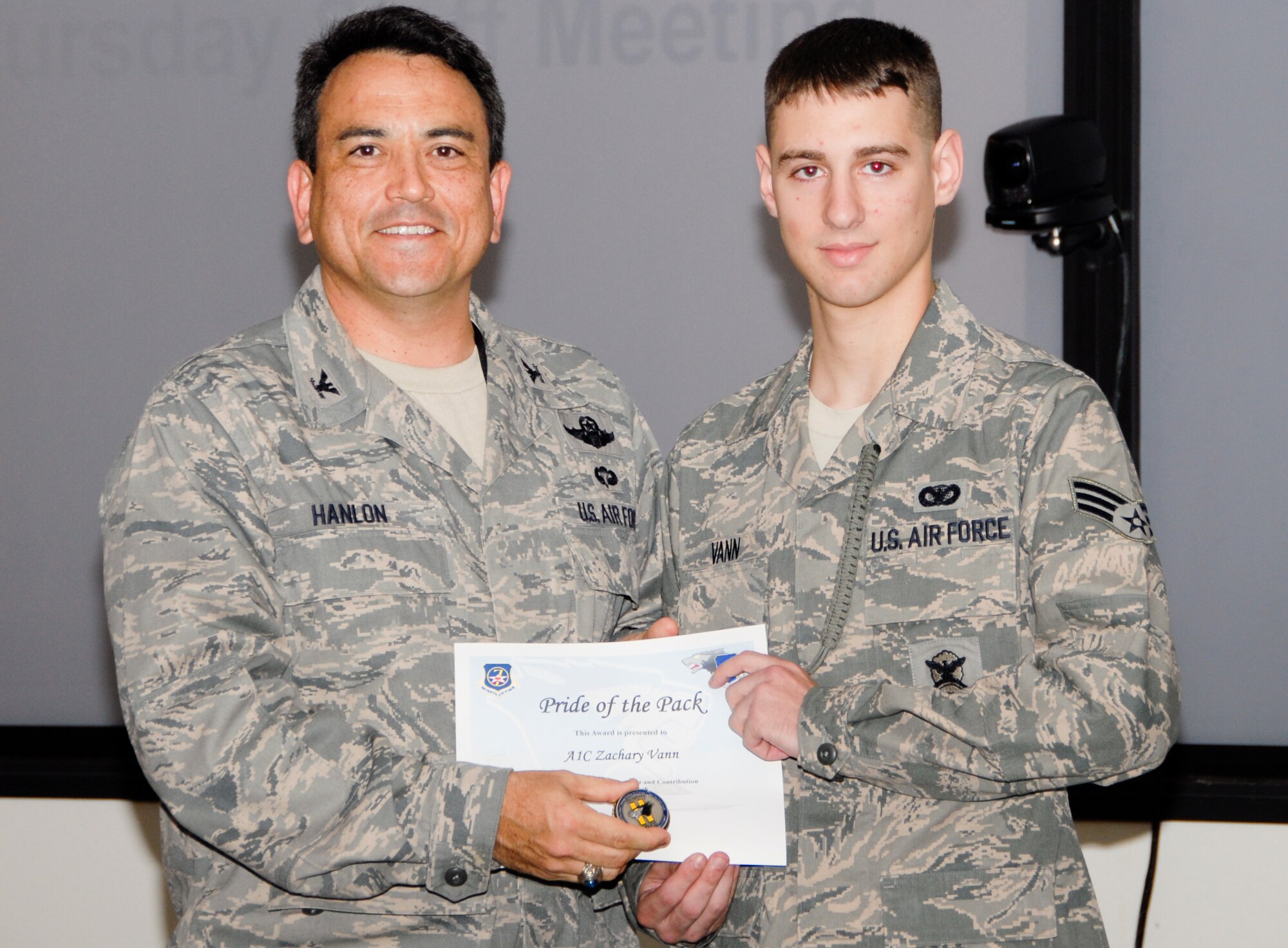 KUNSAN AIR BASE, Republic of Korea -- Col. Hugh Hanlon, 8th Fighter Wing vice commander, presents Senior Airman Zachary Vann, 8th Security Forces Squadron, with a Pride of the Pack award Oct. 14. (U.S. Air Force photo/Capt. Sheryll Klinkel)
