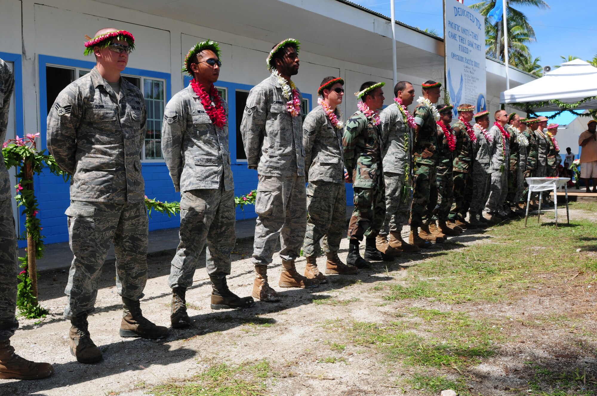 Members of the Pacific Unity engineering team, made up of U.S. Air Force engineers from Yokota, Japan, and U.S. Navy Seabees from San Diego, Calif., are recognized during a dedication ceremony at the Outer Islands High School, in Falalop, Yap, Federate States of Micronesia, on Sep. 22, 2010.  Pacific Unity, a humanitarian civil engineering effort in which 18 engineers completely rebuilt, remodeled and repainted a high school on a remote island in Micronesia. (U.S. Air Force Photo/Master Sgt. Victoria Meyer) 