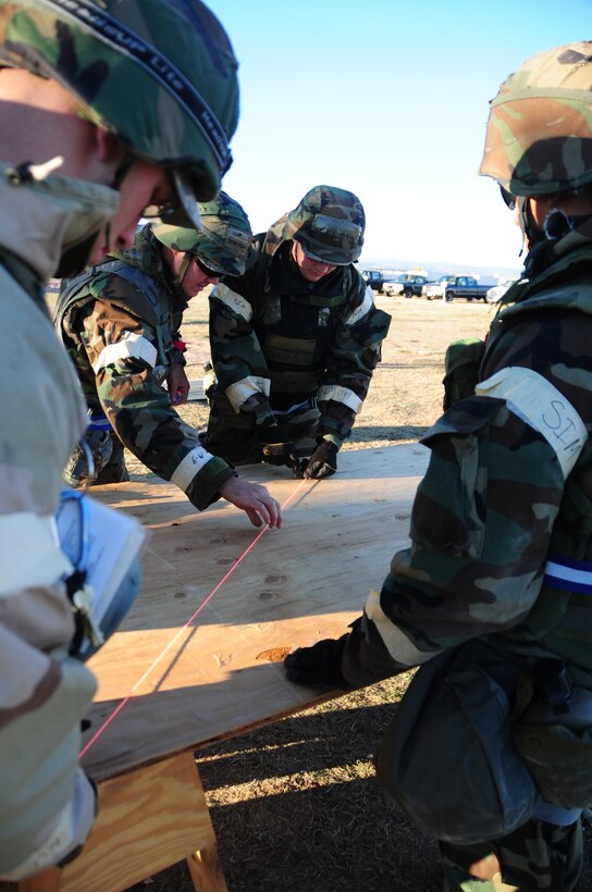 ELLSWORTH AIR FORCE BASE, S.D. - 28th Civil Engineer Airmen trace out plans to construct an entry control gate at Camp Lancer during a Phase II Operational Readiness Inspection, Oct. 14.  Airmen with the 28 CES sharpen their skills by constructing defensive measures around their encampment. (U.S. Air Force photo/Airman 1st Class Anthony Sanchelli)
