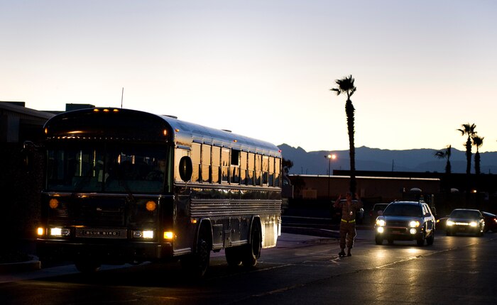 NELLIS AIR FORCE BASE, Nev. -- A bus transports Airmen participating in the Operational Readiness Exercise to the mobility processing center Oct. 13. The ORE tests the 99th Air Base Wing’s ability to implement increased security procedures, gain 100 percent accountability of all Airmen, prepare Airmen for quick deployment and continue with daily operations that help accomplish the Air Force mission. (U.S. Air Force photo by Senior Airman Brett Clashman/Released)