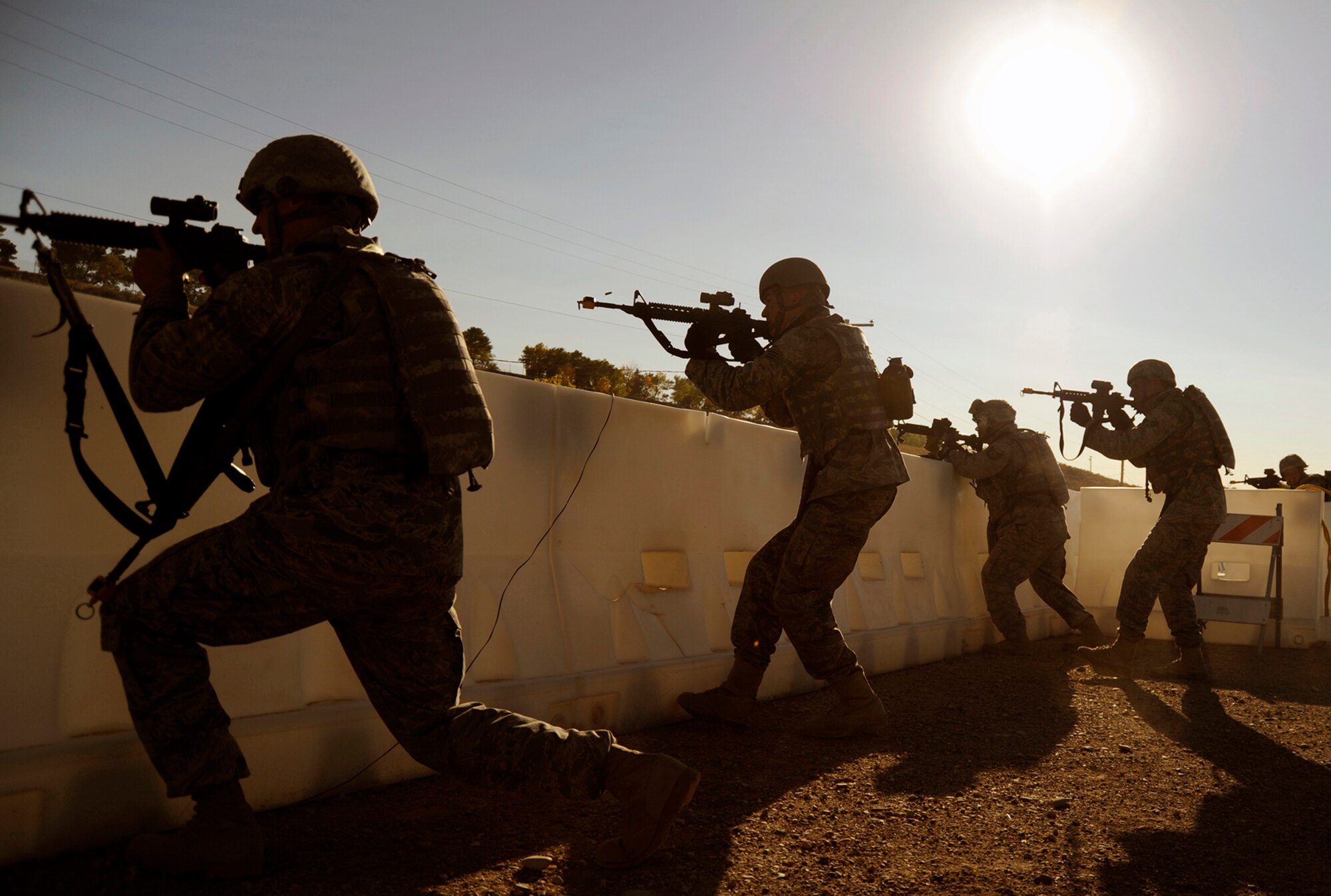 Airmen with the 75th Security Forces Squadron provide cover fire during a Security Forces Combat Readiness Training exercise at Hill Air Force Base, Utah, Oct. 1, 2010. The CRT course provides Airmen with the basic skills needed to deploy, including tactical movements, land navigation, and self aid and buddy care. (U.S. Air Force photo/Airman Allen Stokes)
