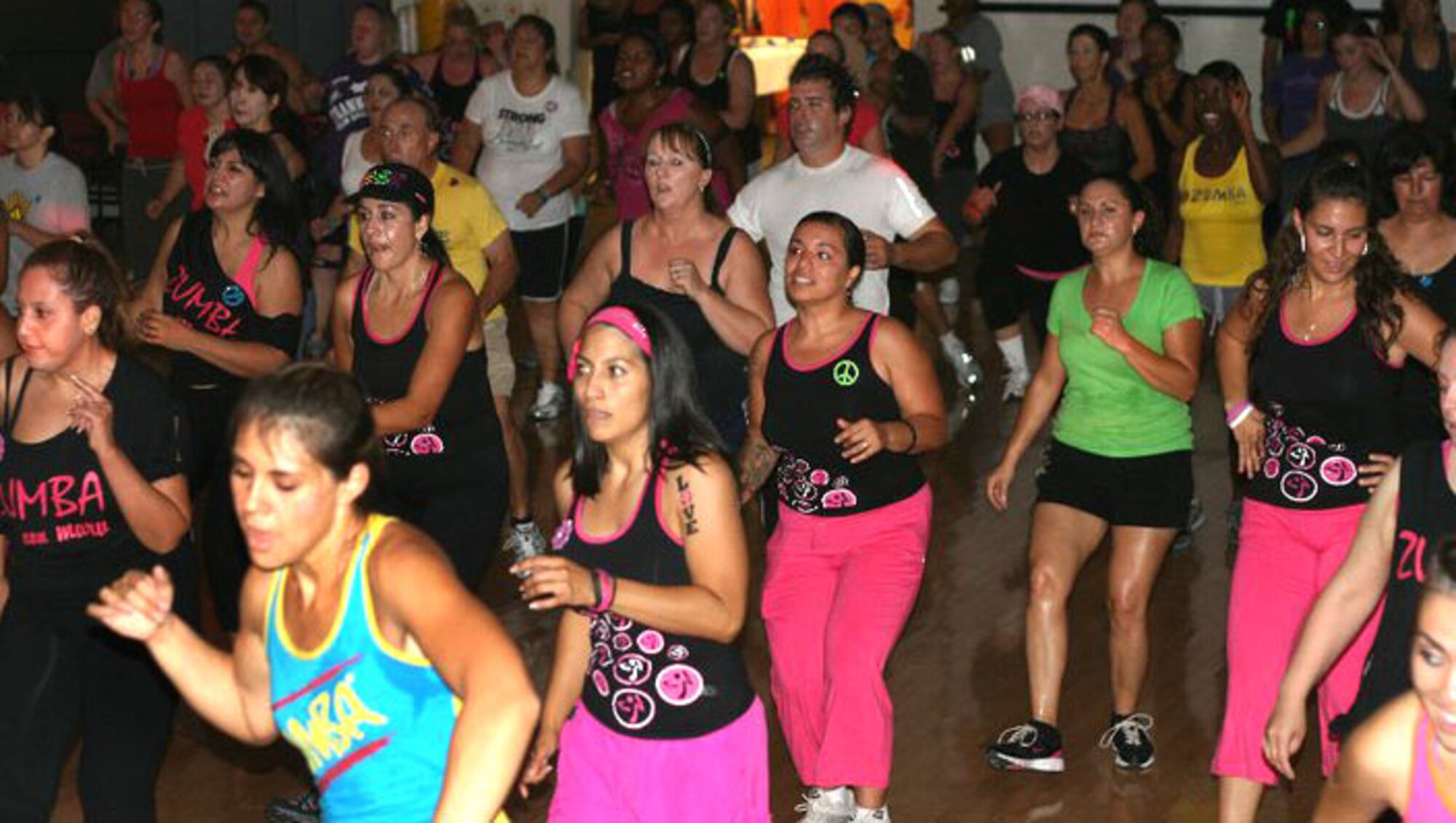 HOLLOMAN AIR FORCE BASE, N.M. -- Members of Team Holloman and residents of Alamogordo, Las Cruces and El Paso, Texas, dance during a ZUMBAthon® event at the Community Activity Center, Oct. 9, 2010, as part of Domestic Violence Awareness Month. The marathon of ZUMBA® -- a fitness program that incorporates Latin rhythms and easy dance moves -- was titled "Dance for a Cause: Peace, Love, STOP Domestic Violence," and more than 200 people attended. Many people who attended the free event donated personal hygiene items for the local Center of Protective Environment. The Center, better known as COPE, provides a safe environment for victims of domestic violence. (Courtesy photo / Released)