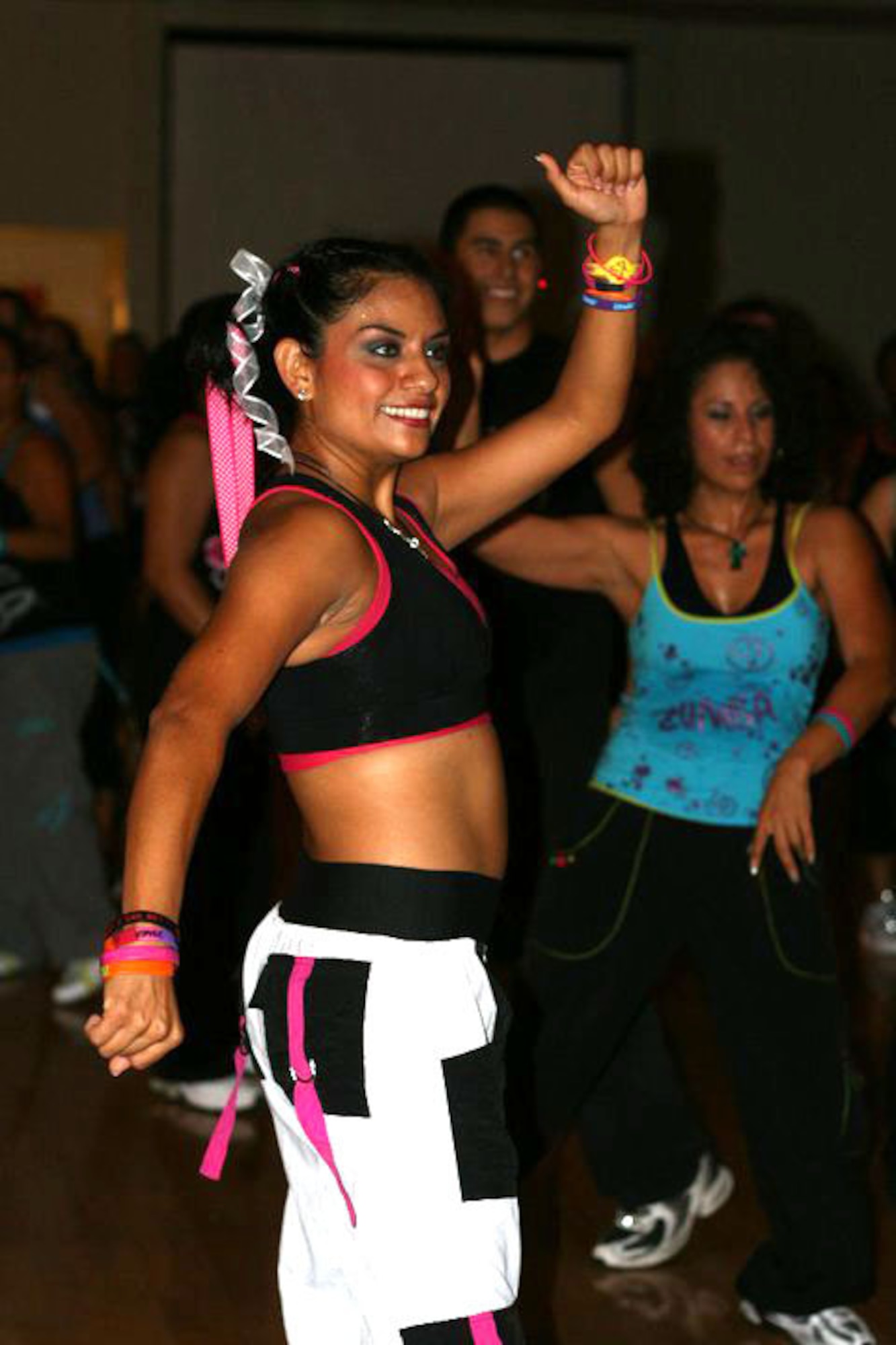 HOLLOMAN AIR FORCE BASE, N.M. -- Zoe Aguirre, a ZUMBA® instructor from El Paso, Texas, dances during a ZUMBAthon® event at the Community Activity Center Oct. 9, 2010. The marathon of ZUMBA® -- a fitness program that incorporates Latin rhythms and easy dance moves -- was titled "Dance for a Cause: Peace, Love, STOP Domestic Violence," and more than 200 people attended. The purpose of the event was to raise awareness of domestic violence while also collecting donations of personal hygiene products for the local Center of Protective Environment. The Center, better known as COPE, provides a safe environment for victims of domestic violence. (Courtesy photo / Released)