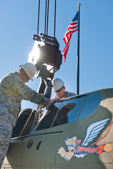 MOODY AIR FORCE BASE, Ga -- Staff Sgt. Richard Rice (left), and Tech. Sgt. RJ Foerster, 23rd Equipment Maintenance Squadron aero-repair craftsmen, secure a crane to a P-40 Warhawk Oct. 14 at what will soon be Moody’s Heritage Park. The Flying Tigers flew P-40 aircraft in 1941 and 1942 when the American Volunteer Group assisted the Republic of China's air force. (U.S. Air Force photo/Senior Airman Jamal D. Sutter)