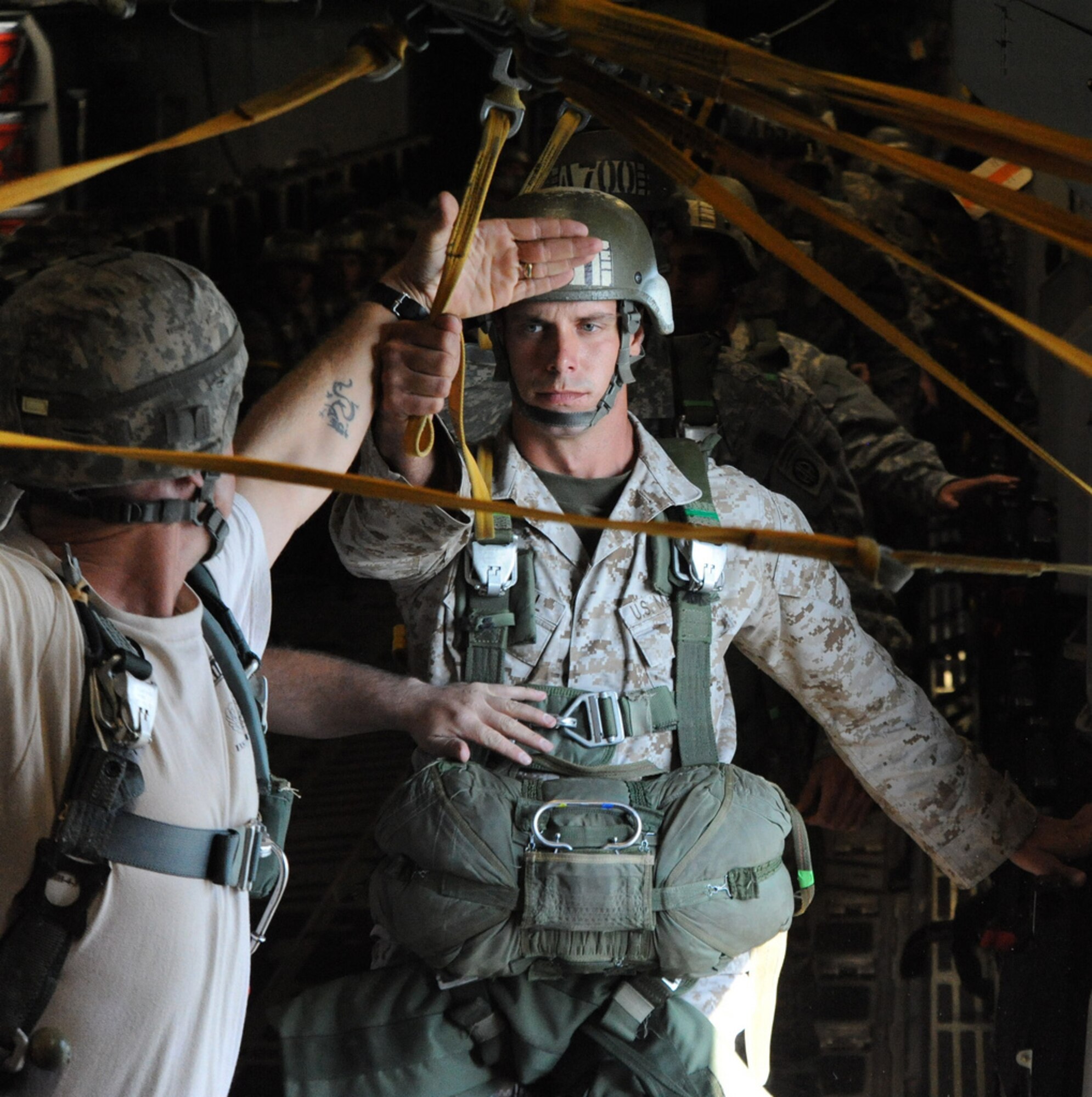 Both from the 507th Airborne School in Fort Benning, GA, a jumpmaster uses non-verbal communication to a paratrooper student in preparation for a jump over the drop zone Oct. 11. A C-17 from the 15th Wing at Joint Base Pearl Harbor Hickam made the long journey to Fort Benning to support the student jump requirements of the 507th Airborne School. (U.S. Air Force photo by Staff Sgt. Nathan Allen)

