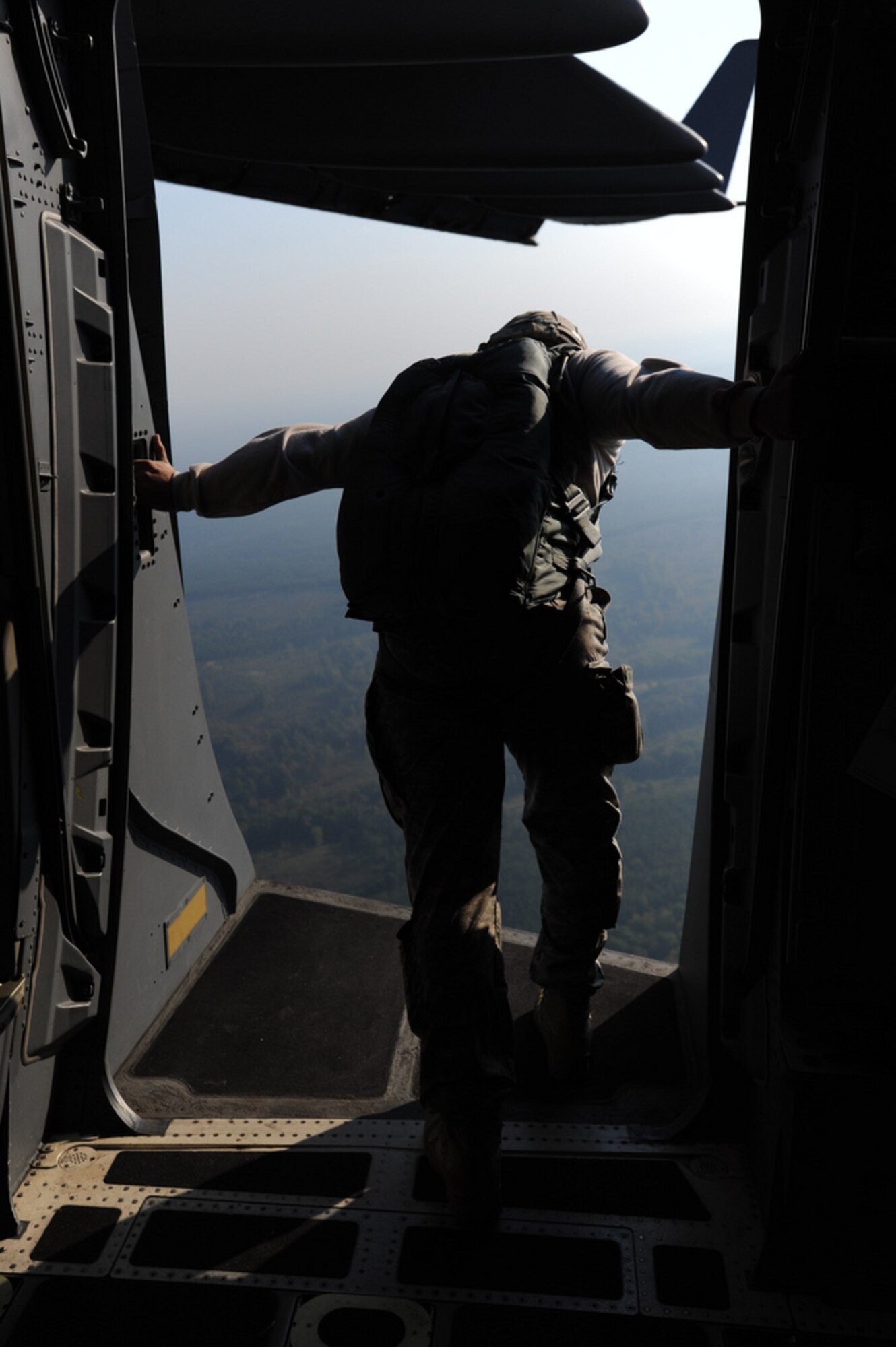 A jumpmaster from the 507th Airborne School at Fort Benning, GA checks the exit door for student paratroopers Oct. 11. A C-17 from the 15th Wing at Joint Base Pearl Harbor Hickam made the long journey to Fort Benning to support the student jump requirements of the 507th AS. (U.S. Air Force photo by Staff Sgt. Nathan Allen)
