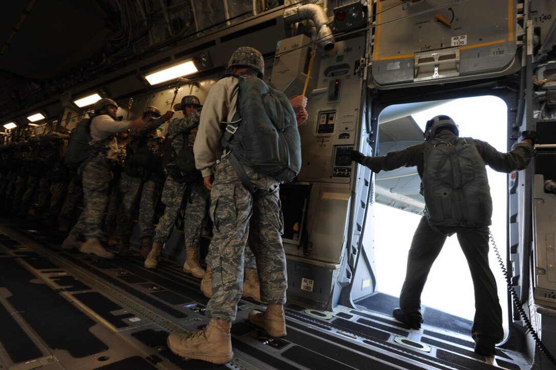 Staff Sgt. Jason Jones, 535th Airlift Squadron loadmaster, checks the exit door of a C-17 in preparation for student paratroopers from the 507th Airborne School to exit the aircraft Oct. 11 at Fort Benning, GA. A C-17 from the 15th Wing at Joint Base Pearl Harbor Hickam made the long journey to Fort Benning to support the student jump requirements of the 507th Airborne School. (U.S. Air Force photo by Staff Sgt. Nathan Allen)
