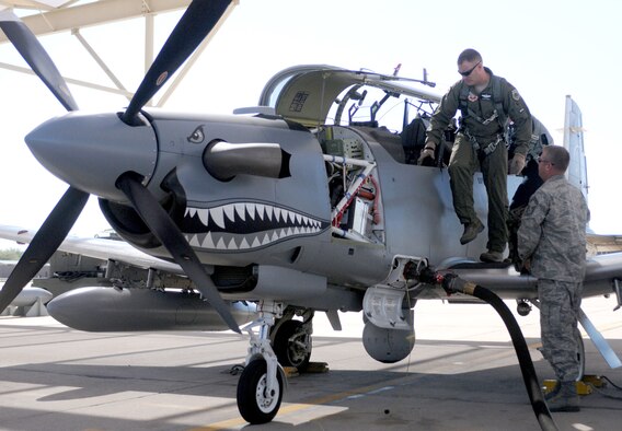 Maj. Jesse Smith exits a Hawker Beechcraft AT-6C after testing the light-attack aircraft's ability to perform a combat search and rescue mission Oct. 7, 2010, at Davis-Monthan Air Force Base, Ariz. Major Smith is one of several pilots invited by the Air National Guard Air Force Reserve Command Test Center to fly the experimental airplane this month and provide recommendations for improving its capability. Major Smith is an A-10 pilot from the 422nd Test and Evaluation Squadron at Nellis Air Force Base, Nev. (U.S. Air Force photo/Maj. Gabe Johnson)
