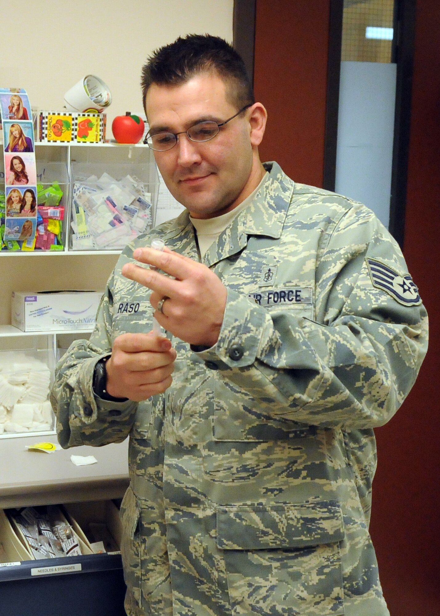 Staff Sgt. Timothy Raso prepares a vaccine for a patient Oct. 7, 2010, Eielson Air Force Base, Alaska. This year's vaccine combats three virus strains, including two A strains of H1N1 and H3N2, and the B strain Brisbane. Sergeant Raso is a 354th Medical Operations Squadron independent duty medical technician. (U.S. Air Force photo/Airman 1st Class Janine Thibault)
