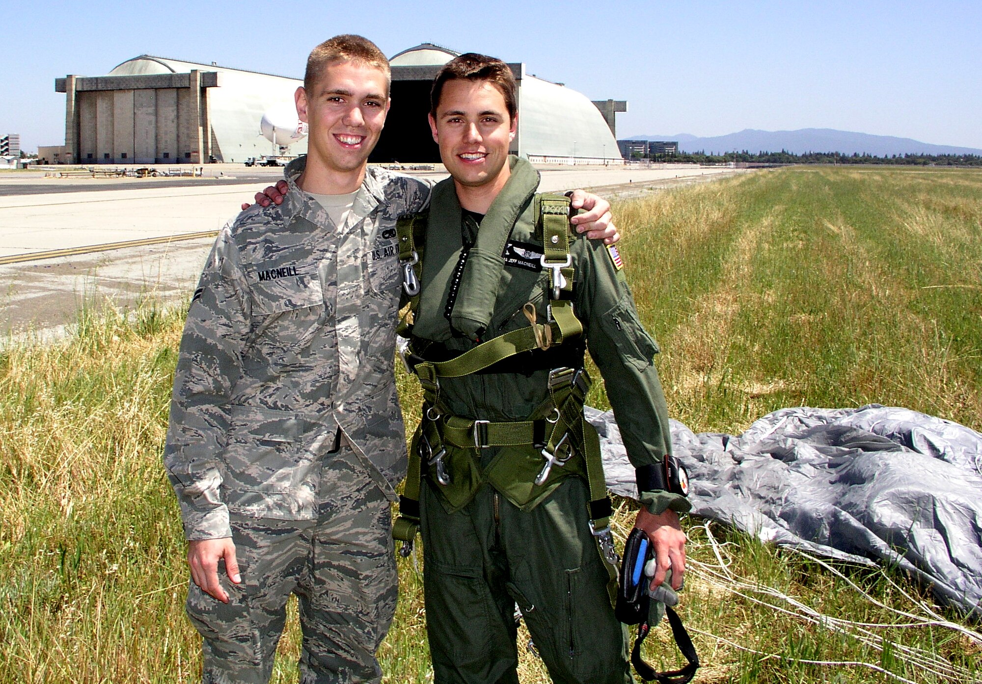 Senior Airman Jeffrey MacNeill, a C-130 Combat Shadow radio operator with the 130th Rescue Squadron, is greeted by his brother, Airman 1st Class Kevin MacNeill, a avionics systems journeyman with the 129th Aircraft Maintenance Squadron, at Moffett Federal Airfield, Calif. May 20, 2010, after a tandem parachute jump with pararescuemen from the 131st Rescue Squadron. Senior Airman ManNeill is this months portrait of a professional. (photo courtesy of Airman 1st Class Kevin MacNeill)