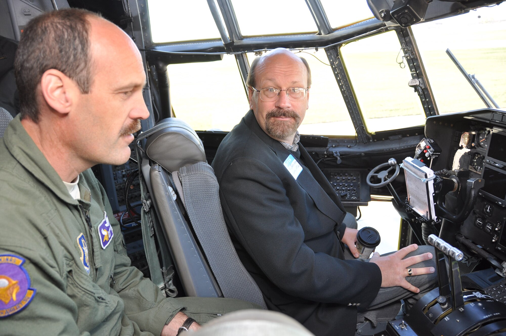 Mark Jarvinen talks with Master Sgt. Shannon Moerke, 96th Airlift Squadron flight engineer, about C-130 cockpit operations during Clergy Day Oct. 13. (Air Force Photo/Paul Zadach)
