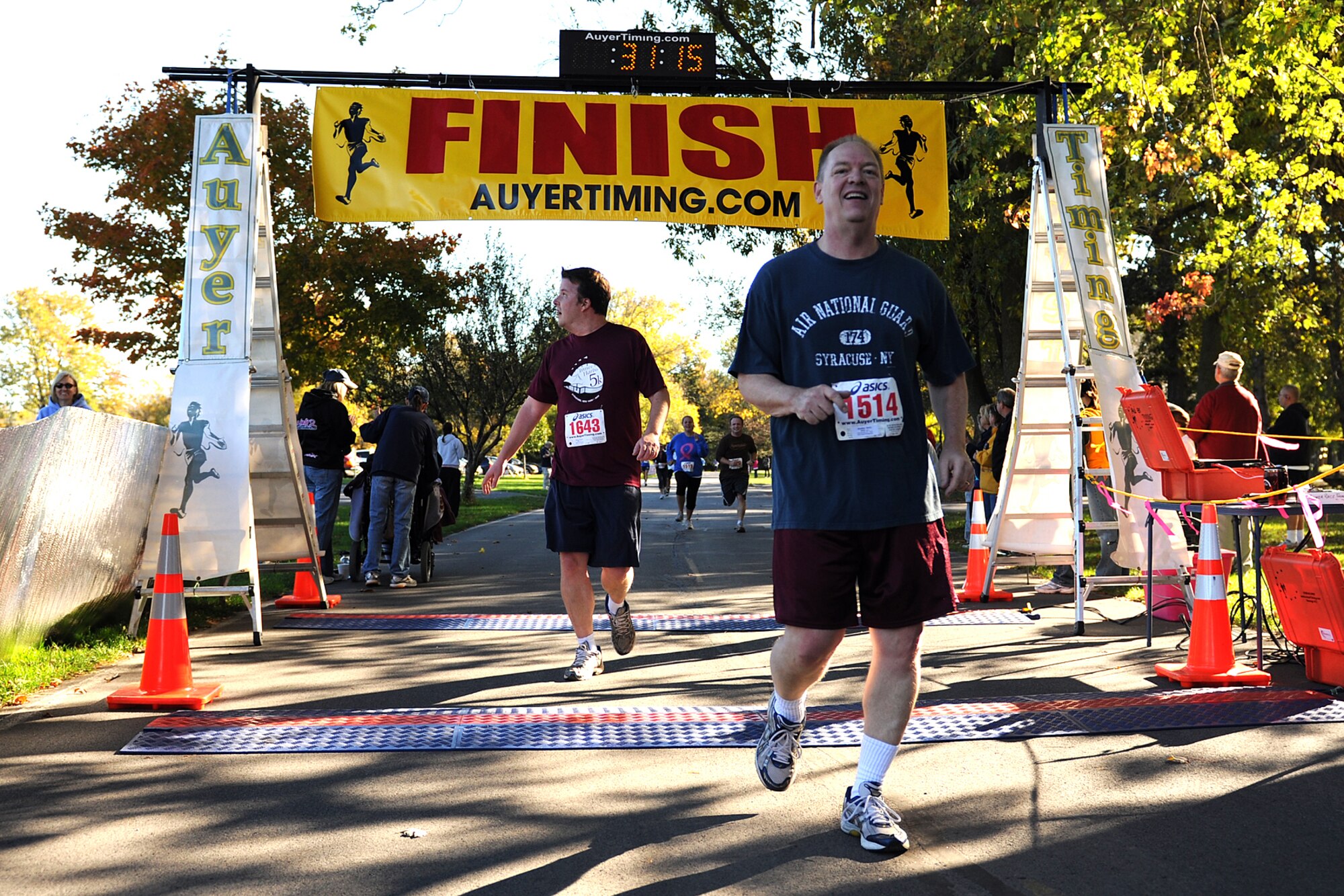 174th Fighter Wing (FW) Commander Col. Kevin Bradley crosses the finish line during the 1st Annual Hancock Field Family Readiness Program 5K Run. Col. Bradley was one of more then 200 runners who came out to support the 174th FW Family Readiness Program. Col. Bradley said, "We're here to support the Family Readiness Program, because the families play as big a supportive role in our mission as the unit members do. Our members couldn't do their jobs if it was not for the support of the families.". The run was held on October 9, 2010 at the Willow Bay shelter in Onondaga Lake Park. (USAF Photo by: SSgt. James N. Faso II/Released)


