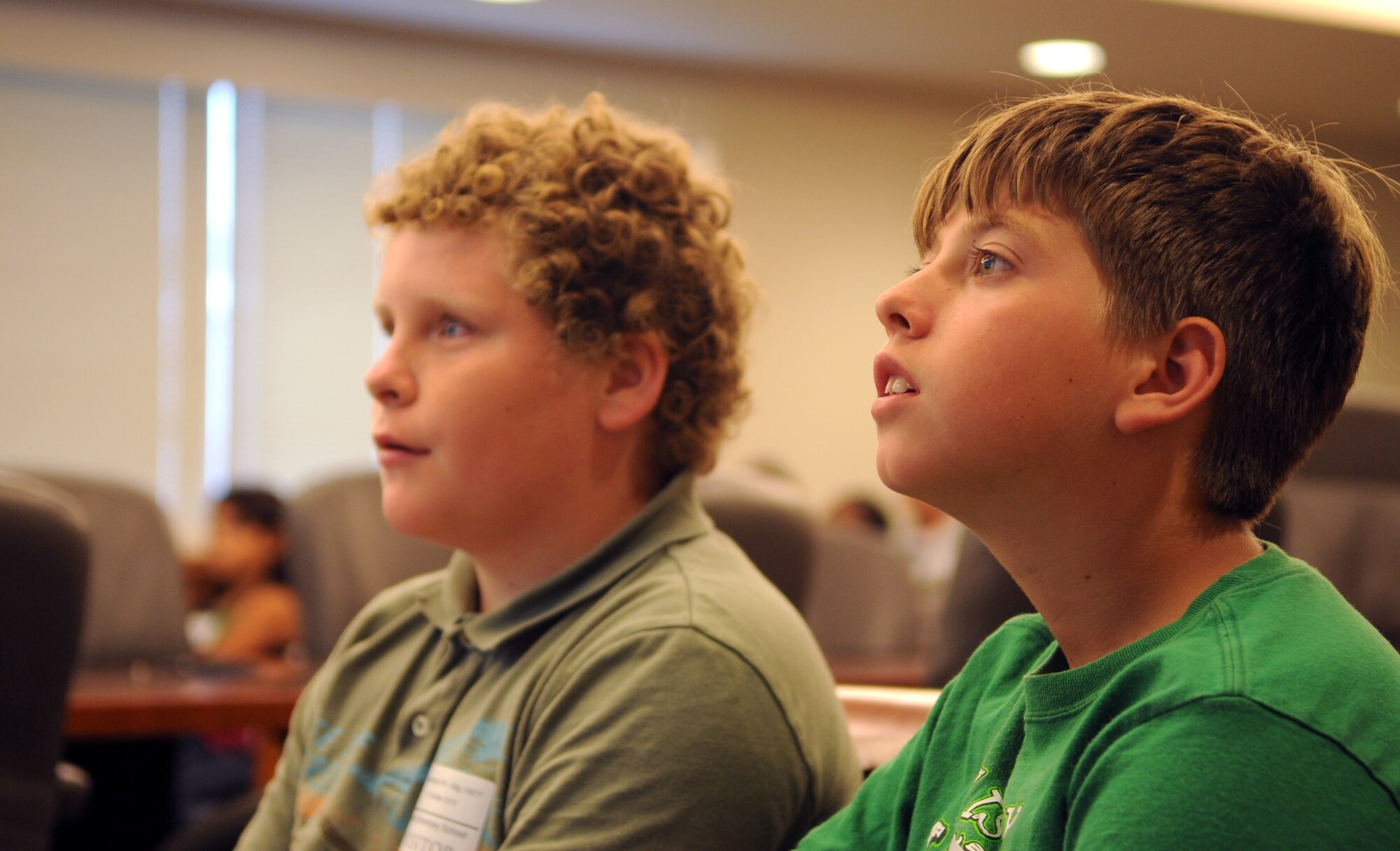 VANDENBERG AIR FORCE BASE, Calif. -- Two students from the 5th grade class at May Grisham School listen to a briefing given by Brig. Gen. Jane Rohr, the 14th Air Force acting vice commander, about space operations here Tuesday, Oct. 12, 2010. This briefing was just one stop out of many during the 5th grader’s tour of Vandenberg. (U.S. Air Force photo/ Senior Airman Ashley Reed)