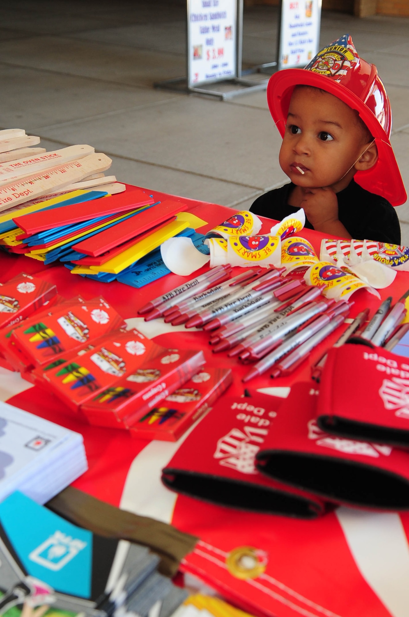 BARKSDALE AIR FORCE BASE, La. -- Justin Smith, 2, son of Senior Airman Tasha Holmes, 2nd Communications Squadron, chooses from fire safety goodies provided by the Barksdale Fire Department outside the Barksdale Base Exchange Oct. 7. Members from the fire department were on site for two days to greet BX patrons and discuss the importance of fire safety as part of Fire Prevention Week. (U.S. Air Force photo by Senior Airman Joanna M. Kresge)