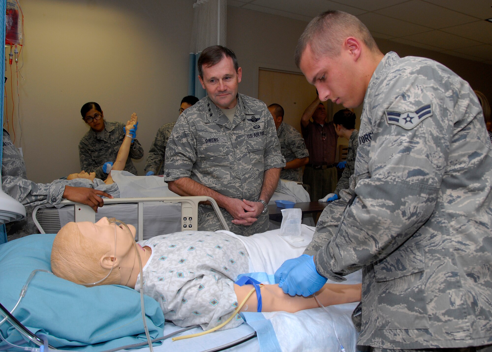 Lt. Gen. Douglas Owens (center), vice commander of Air Education and Training Command, watches as Airman 1st Class Hunter Newsome, an Airman in Training at the 383rd Training Squadron, performs a procedure on a "patient" Oct. 13 during the general's first visit to Sheppard Air Force Base. The general received briefings, flew with the 80th Flying Training Wing and toured technical and medical training at the 82nd Training Wing. (U.S. Air Force photo/Harry Tonemah)