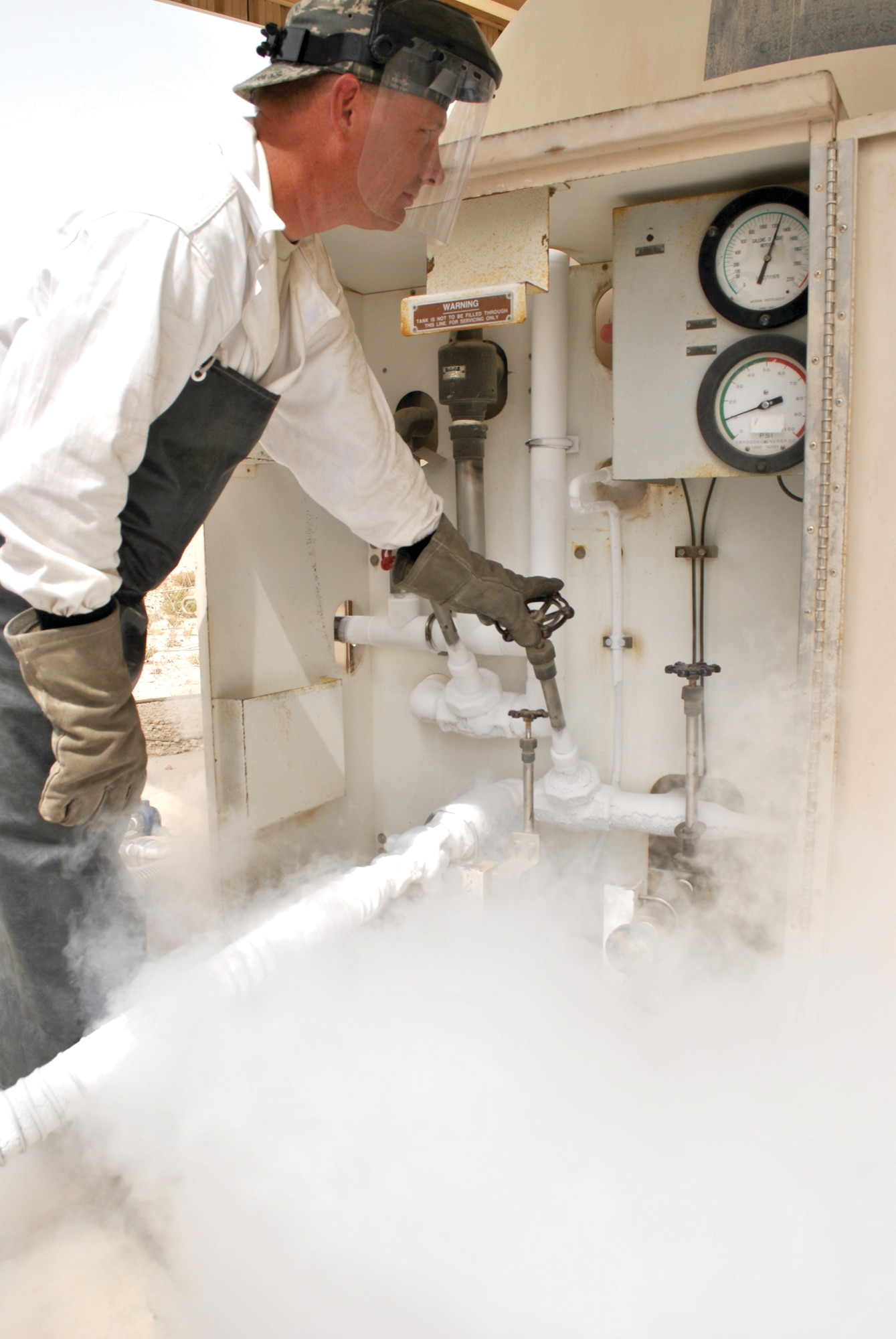 Tech. Sgt. Marty Phillips, 379th ELRS cryogenics technician, checks the pressure on a liquid oxygen tank during a refueling here recently. The cryogenics shop receives up to 9,200 gallons of cryogenic fuel a week. (U.S. Air Force photo/Staff Sgt. Nika Glover).