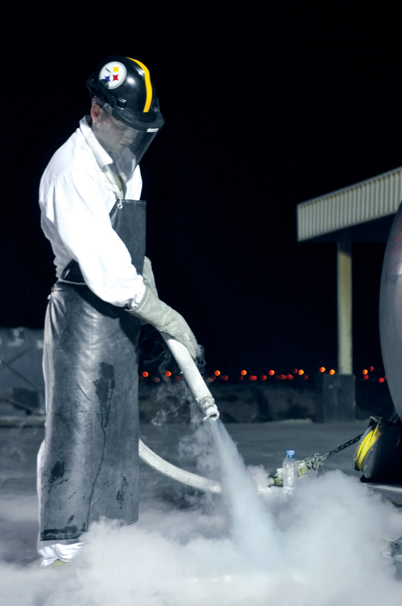 Sergeant Crom, 379th ELRS cryogenics technician, releases liquid oxygen from a tank here Oct. 10. Releasing some of the oxygen from the tanks prevents pressure build up. (U.S. Air Force photo/Staff Sgt. Nika Glover)