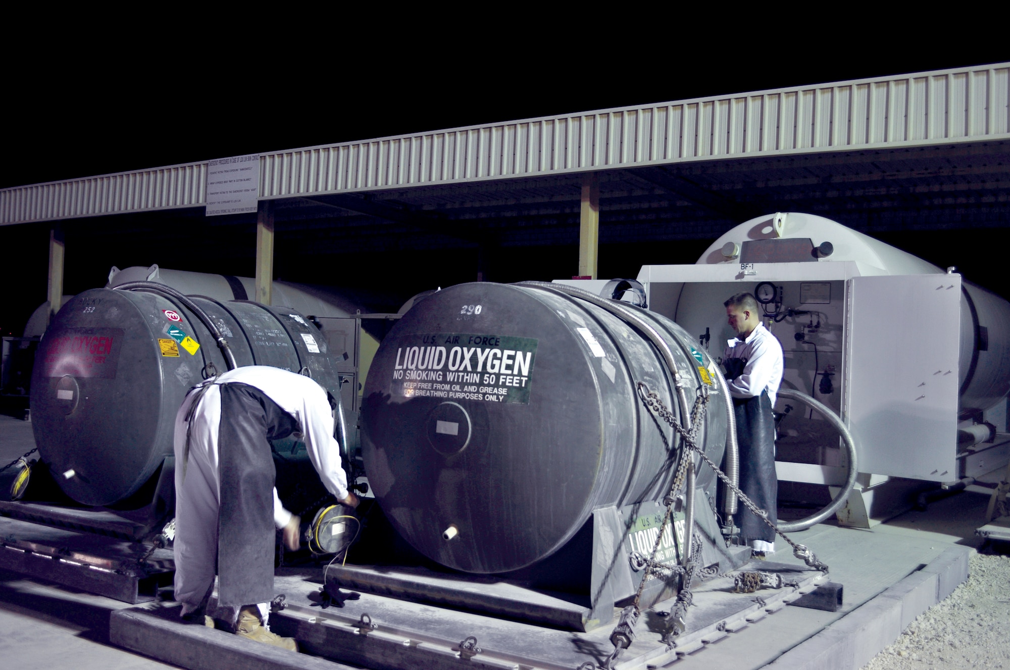 Sergeants Crom and Dietz perform a maintenance check on a tank used to hold liquid oxygen. The oxygen in liquid form is extremely cold and boils at subzero temperatures. For this reason, the oxygen has to remain in a tank deemed safe for its containment. As cryogenics technicians, the Airmen have a thorough knowledge of how to maintain the tanks according to Air Force instruction.