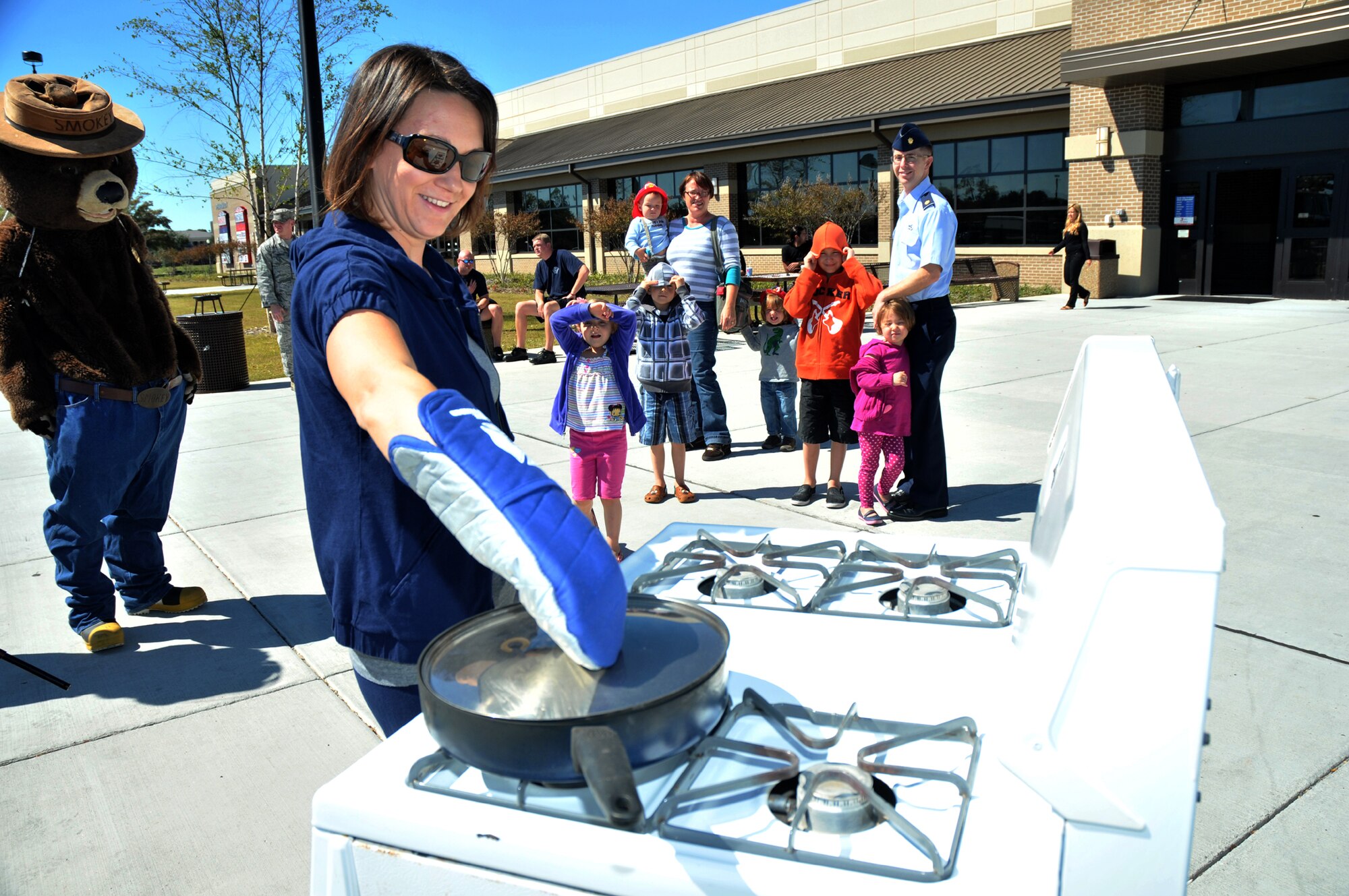 Sarah McCraine participates in a stove fire demonstration Oct. 4 in front of the exchange. Her husband is Maj. Rodney McCraine, 403rd LRS.  (U.S. Air Force photo by Adam Bond)
