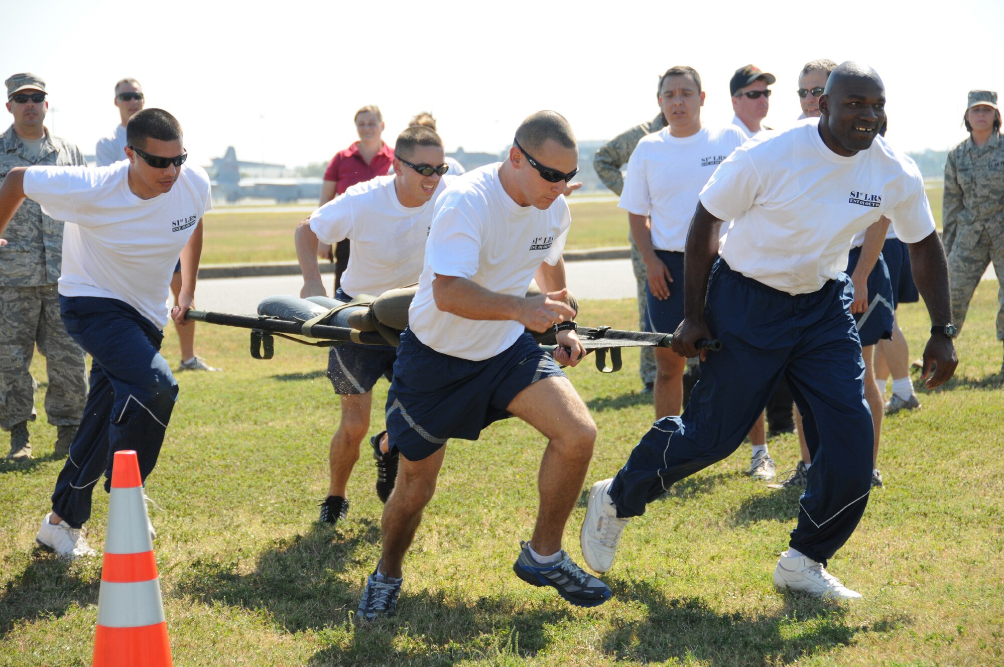 From left, Staff Sgt. Jose Ramos, Senior Airman Marc Skinner and Staff Sgts. Brian Bradley and Johnny Blakely from the 81st Logistics Readiness Squadron's Bad Mother Truckers team compete in the Rescue Randy race.  The team finished third overall.  (U.S. Air Force photo by Kemberly Groue)