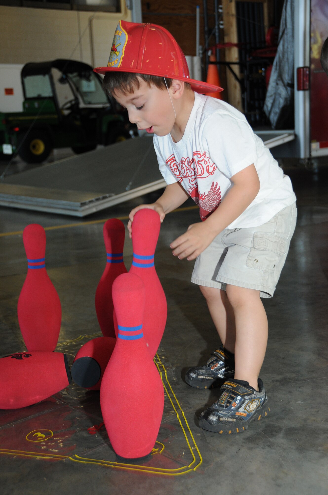 Four-year-old Domonic Wince, son of Staff Sgt. Billy and Janis Wince, 81st Aerospace Medicine Squadron, sets up bowling pins at the fire department's open house, Oct. 9.  (U.S. Air Force photo by Kemberly Groue)