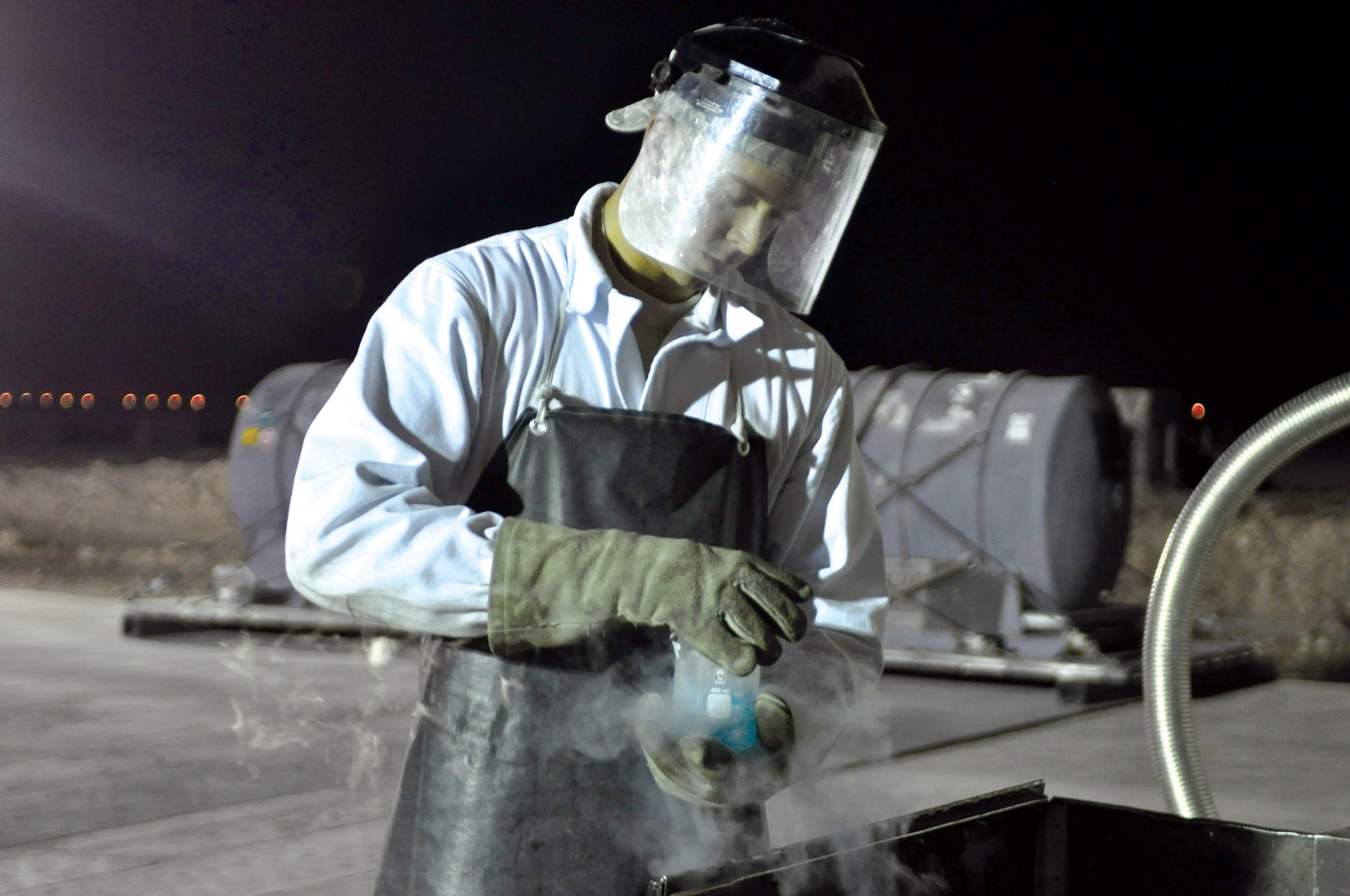 Staff Sgt. Michael Dietz, 379th Expeditionary Logistics Readiness Squadron cryogenics technician, pulls a sample of liquid oxygen from a cart. When the liquid oxygen boils off, Sergeant Dietz does an odor test to ensure the sample is pure. (U.S. Air Force photo/Staff Sgt. Nika Glover)