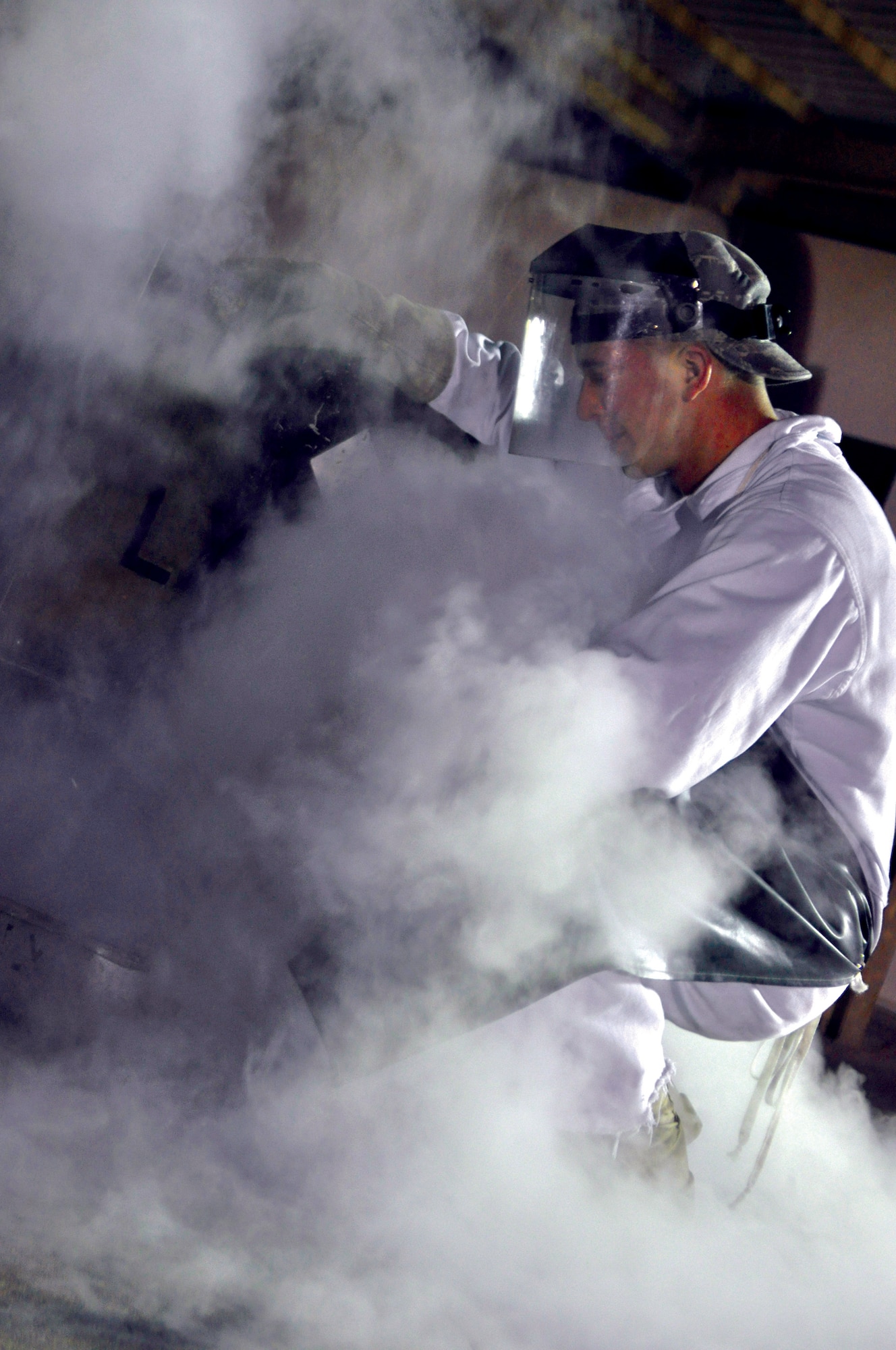 Staff Sgt. Michael Dietz, 379th Expeditionary Logistics Readiness Squadron cryogenics technician, pulls a sample of liquid oxygen from a cart. When the liquid oxygen boils off, Sergeant Dietz does an odor test to ensure the sample is pure. (U.S. Air Force photo/Staff Sgt. Nika Glover)