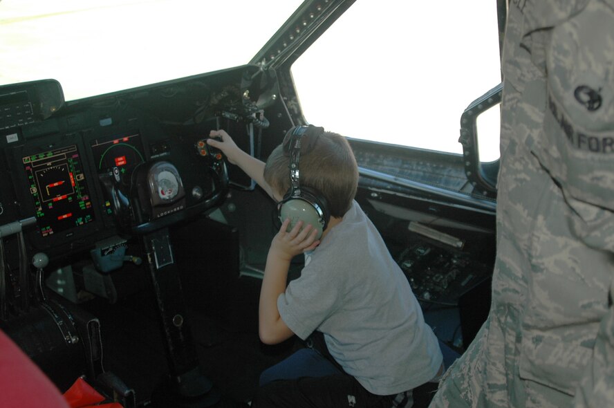 Brandon Hanechak, honorary 337th Airlift Squadron C-5 pilot, sits at the controls of a C-5 during a tour of the plane Oct. 2.  Brandon came to Westover as part of the Pilot for a Day program that recognizes children who have faced medical hardships with courage.